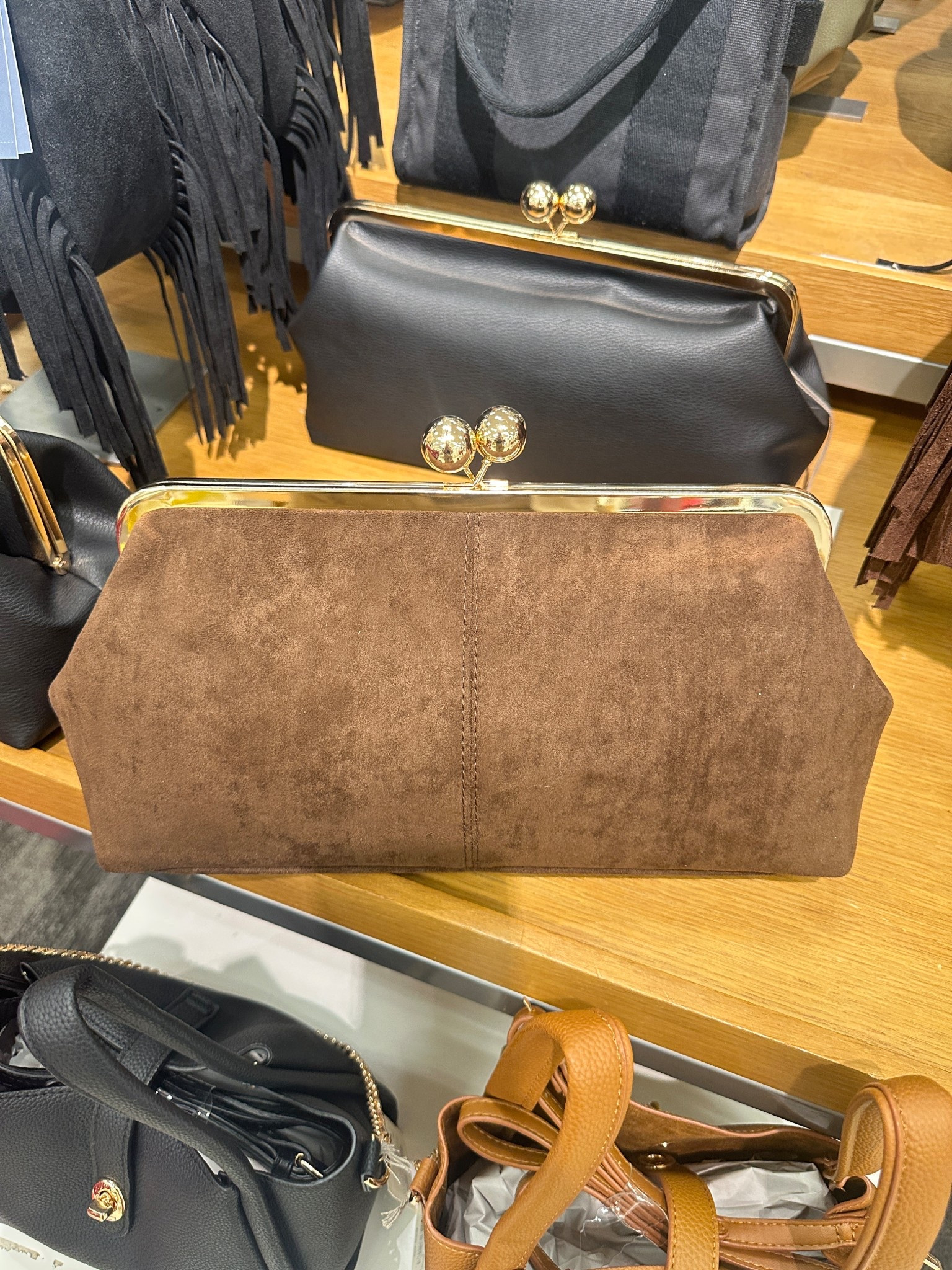 This kiss lock bag has a strap that can be added. Also comes in black. So chic! 

#LTKItBag #LTKFindsUnder50