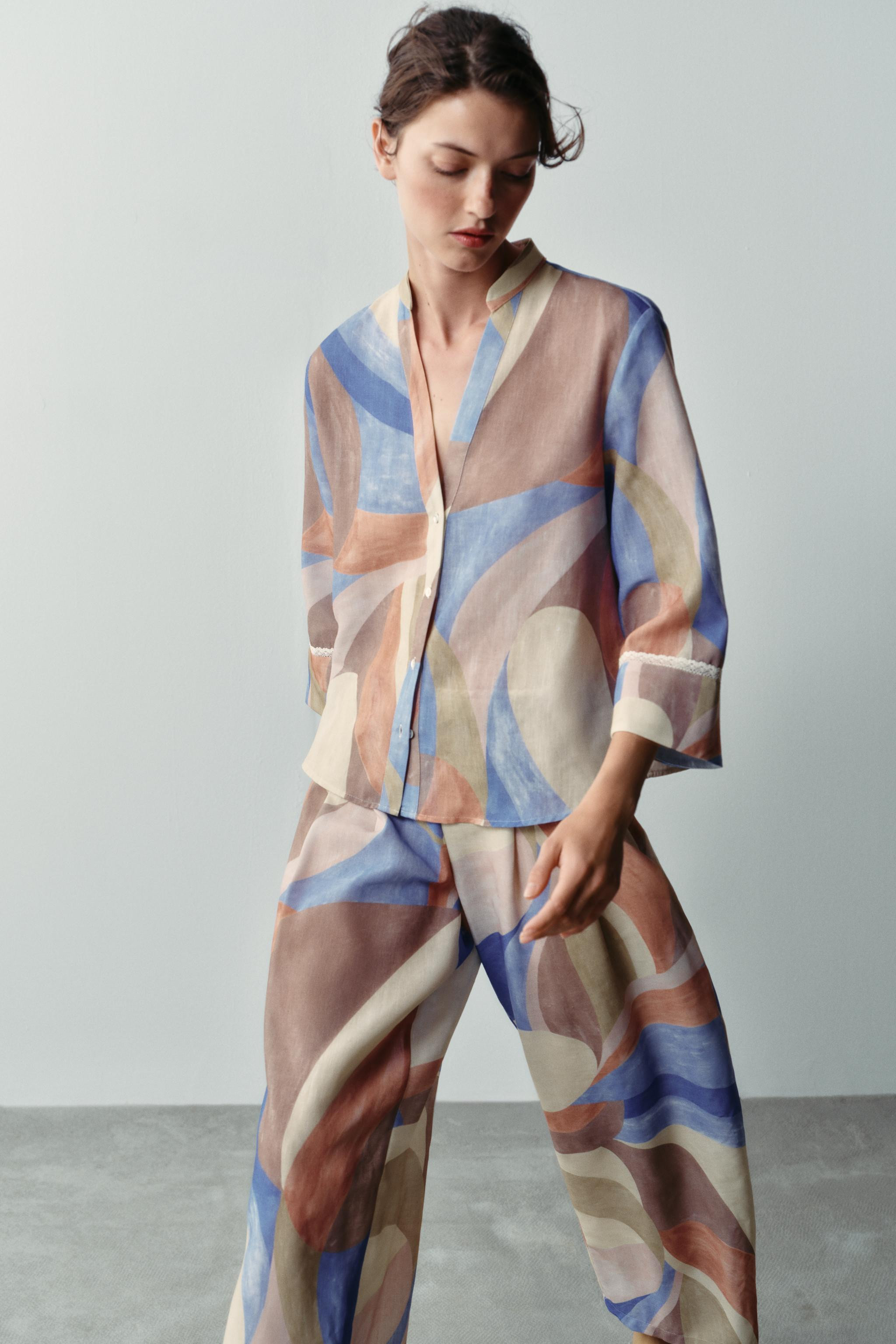 Model height: 176 cmRound neck shirt with a V-neckline and below-the-elbow sleeves featuring lace... | Zara UK