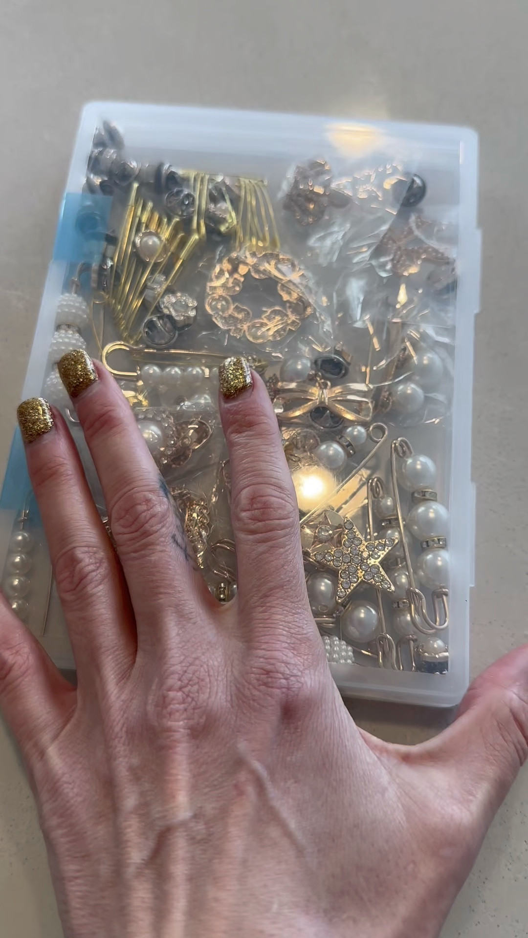 Small details make the biggest difference in a curated wardrobe. 🌟 These compact organizers are my go-to for keeping my pearl collection polished and ready for any outfit. Check out the link in my bio to shop this find and refresh your own vanity setup! #StyleInspo #HomeOrganization #AccessoryAddict #ShopMyLook

My Accessory and Brooch Organization Breakdown
• The Product: I’m using small, clear plastic flip-top storage containers designed for organizing tiny items.
• The Items: I am organizing a variety of gold-toned pearl pins and decorative hair accessories.
• The Top: For a cozy day of organizing at home, I’m wearing a grey marl henley sweater with prominent brown buttons.
• The Details: My nails are styled with a festive gold glitter polish, which complements the gold hardware on the accessories.
• The Vibe: This is all about "functional aesthetic"—taking the time to categorize accessories so that the finishing touches of an outfit are always within reach.

clear jewelry organizers, mini storage containers, pearl pin collection, gold hair accessories, closet organization, vanity storage, grey henley sweater, gold glitter nails, home organization hacks, LTKhome

#LTKmomlife #LTKOver40 #LTKgrwm