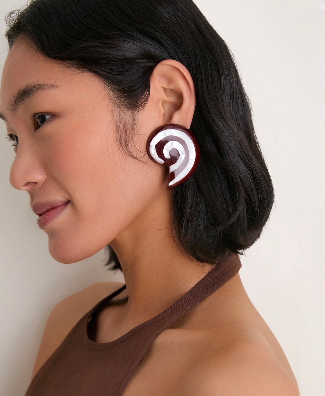 JULIETTA
Brown Spira Earrings

Artfully crafted from real mother-of-pearl blended with resin, these lightweight clip-ons offer a sculptural, statement-making silhouette. Perfect for workdays, brunches, or casual nights out, pair them with neutral tones or earthy textures to highlight their organic glow

#LTKMothersDay #LTKWorkwear #LTKSeasonal