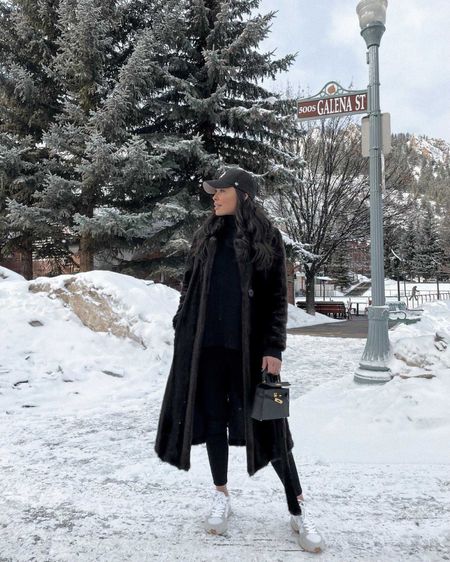 Kat Jamieson of With Love From Kat wears a winter outfit. Black faux fur coat, baseball hat, leggings, sneakers, casual style.

#LTKSeasonal