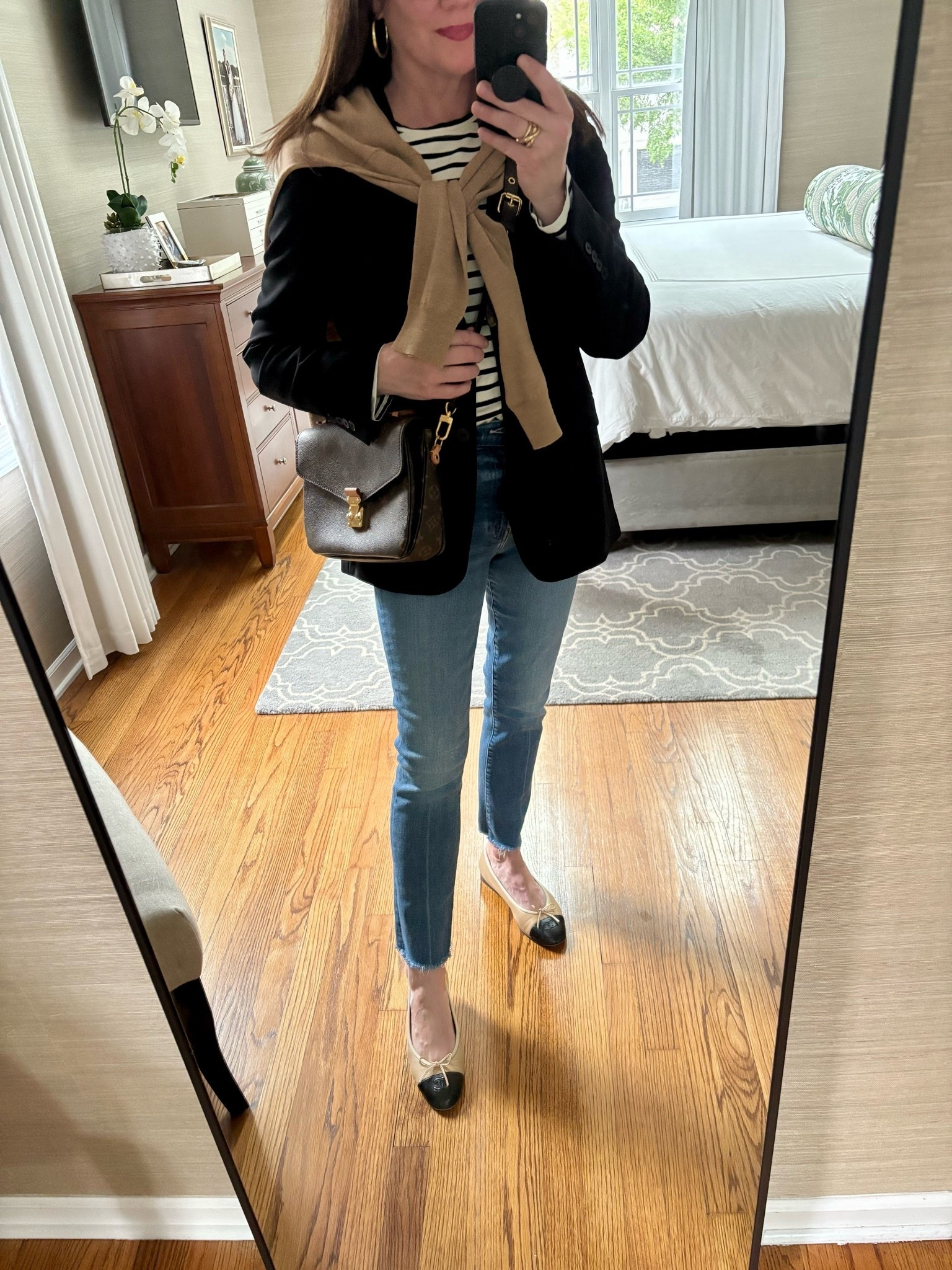 A black blazer, striped tee, jeans and flats make for a an elevated casual look!
