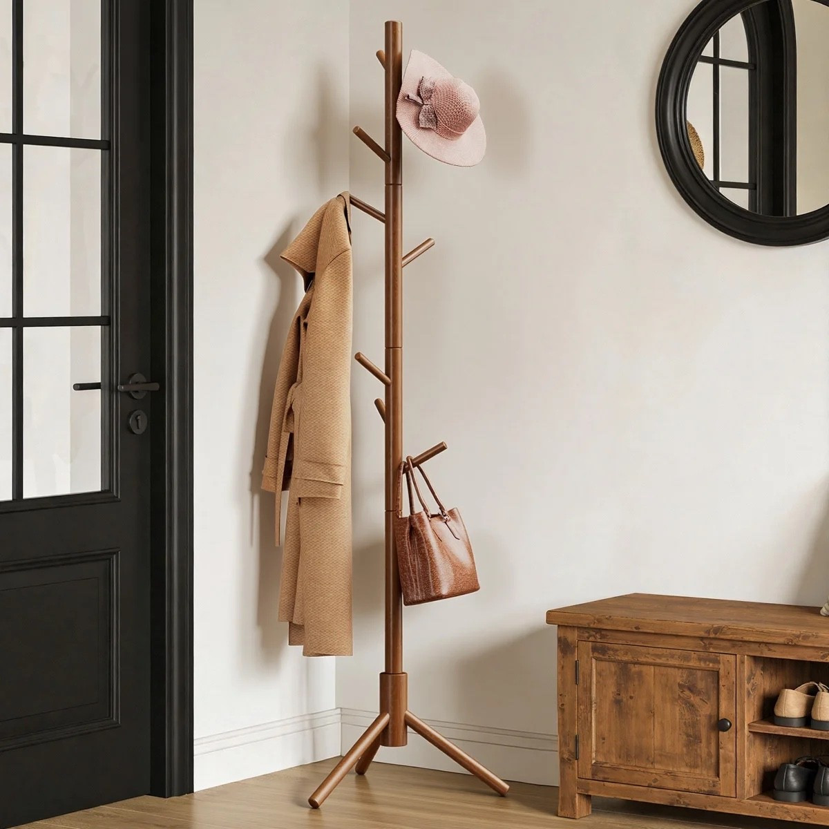 This freestanding wooden coat rack from Wayfair is the kind of entryway piece that’s actually useful without taking up much visual space. The warm wood finish, slim tree-style shape, and 8 hooks give you spots for coats, hats, bags, and umbrellas, and I like that it comes with 3 height options depending on where you’re using it. The round black wall mirror next to it makes the whole corner feel more finished.