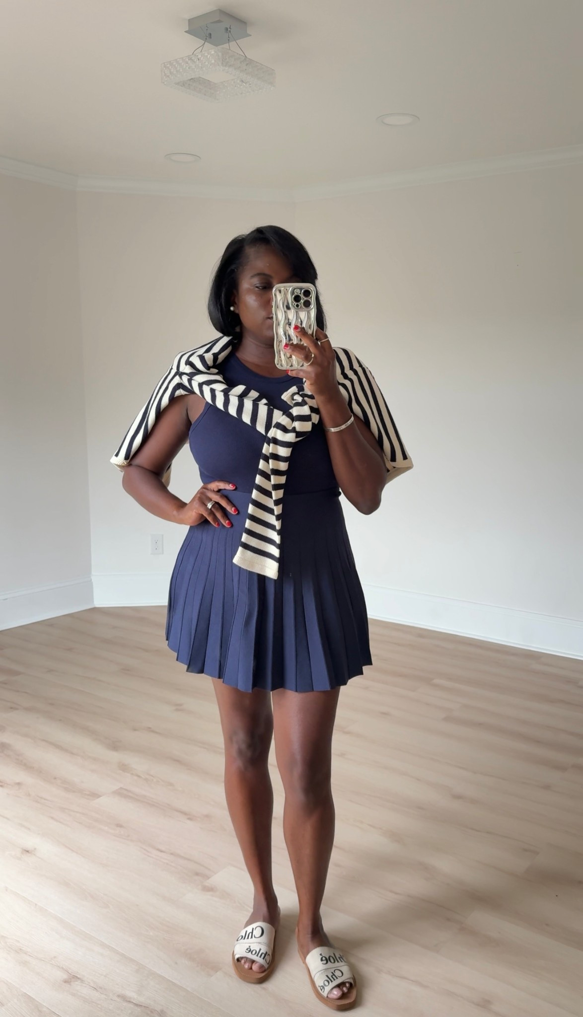 Athletic wear, tennis skirt, striped sweater, casual on the go mom look. 

#LTKActive #LTKFamily