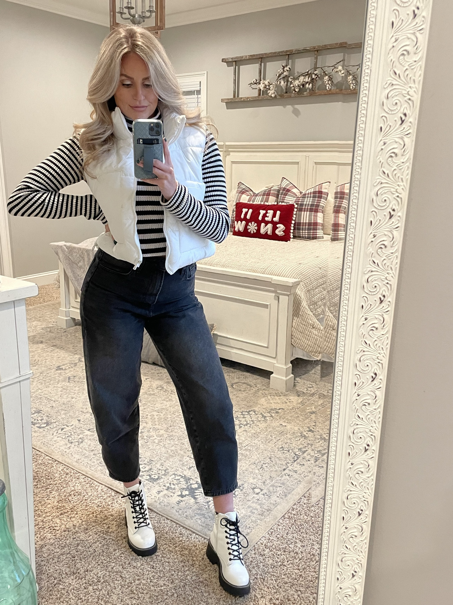 Black and white striped, ribbed, movkneck top with white puffer vest, black gaucho, tapered, balloon jeans and white lace up boots

#LTKsalealert #LTKGiftGuide #LTKSeasonal