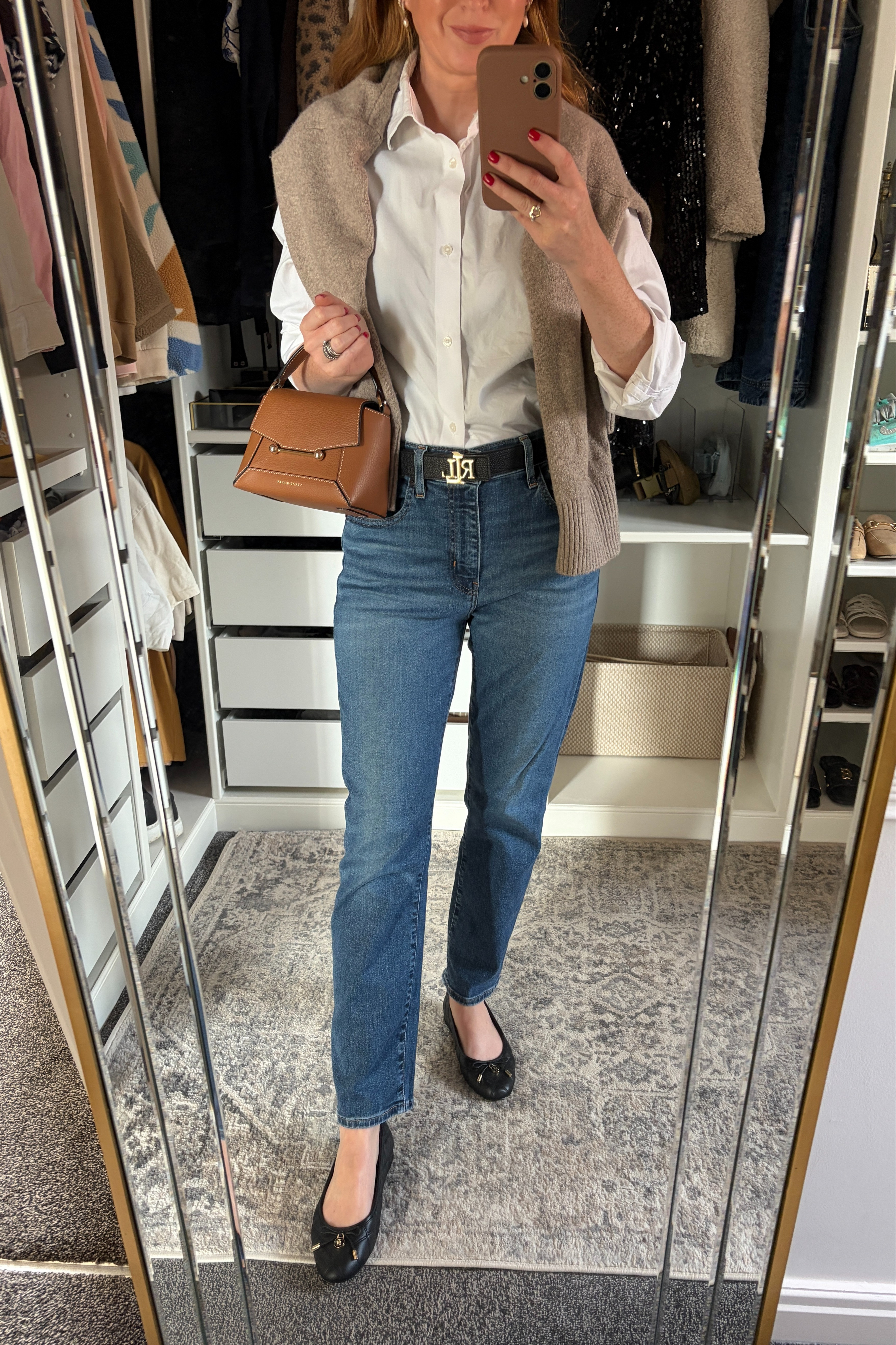 The autumn outfit formula I keep coming back to 🤎 Classic white shirt, straight leg jeans and a cosy knit draped over the shoulders, finished with ballet flats and my favourite tan bag. Perfect for coffee runs, running errands & everything in between 🍂✨ fall fashion hauls, business casual workwear 

 #LTKautumn #LTKworkwear #LTKbag