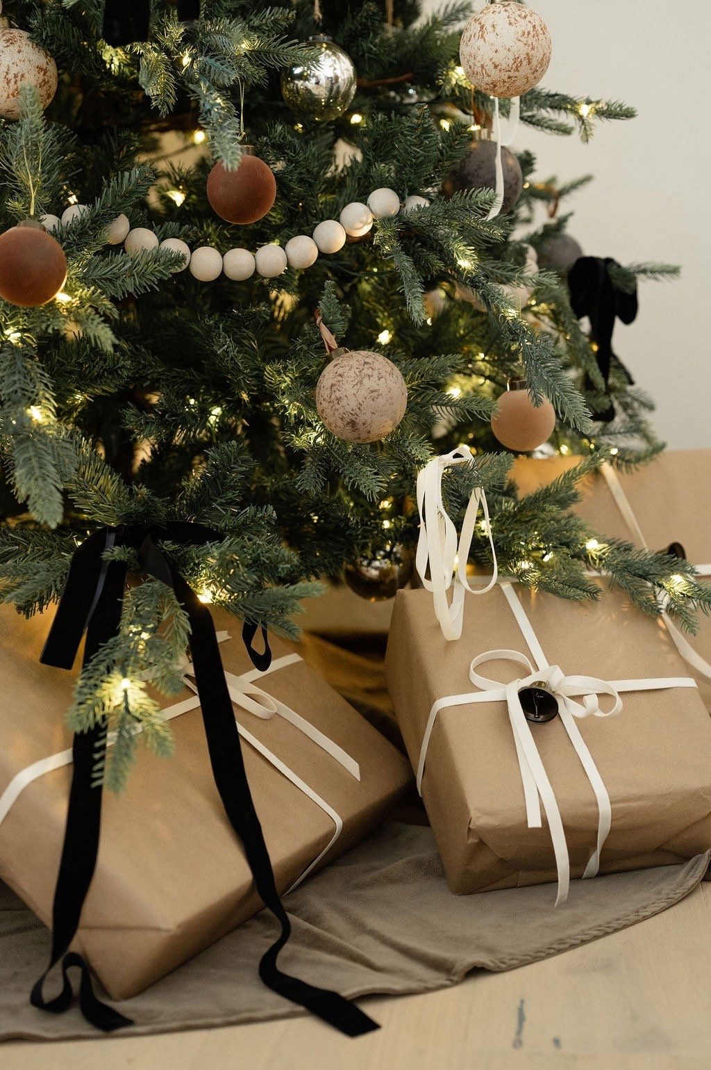 The coziest Christmas tree details 🤍🎄 Loving these neutral ornaments, wood bead garlands, matte earth-tone baubles, and simple Kraft paper gift wrap tied with velvet + satin ribbon. Perfect inspo for neutral Christmas decorating, modern classic holiday style, minimal gift wrapping ideas, LTK Christmas tree finds, and cozy winter home decor.

#LTKHoliday #LTKHome #LTKSeasonal