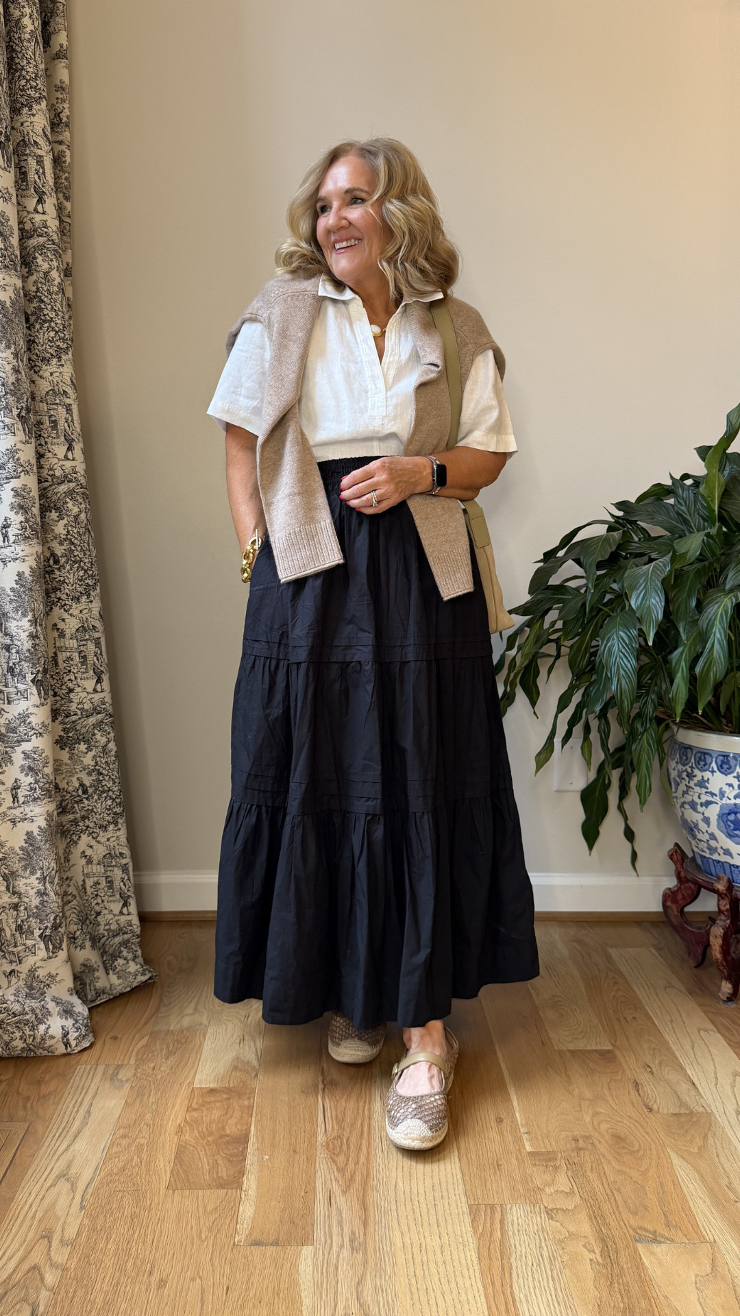 A crisp white top paired with a flowy black maxi skirt always feels timeless, and the lightweight neutral sweater over the shoulders adds the perfect polished touch. Finished with woven Mary Jane flats and a neutral crossbody for an easy elevated everyday look. 🫶🏻 

 #LTKootd #LTKSeasonal #LTKOver40