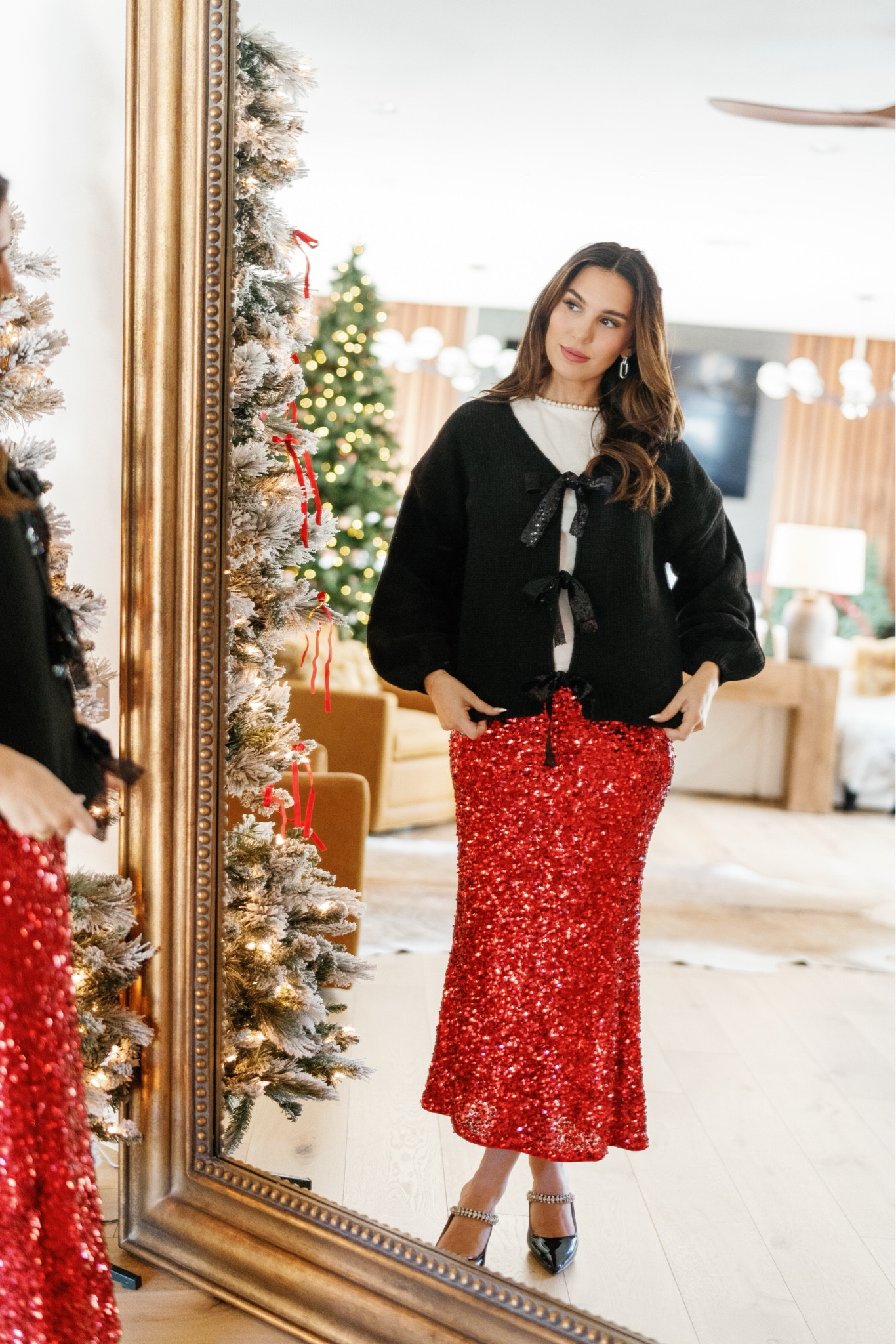 Rocking around the Christmas tree in this sparkly red sequin skirt from Amazon! It’s the perfect piece to wear for your holiday parties, just switch it out for different tops and shoes! I accessorized the look with my go-to silver drop link earrings, bow cardigan, mule heels, and hair bow!
#winteroutfit #semiformal #holidaywardrobe #shoeinspo #celebritystyle

#LTKStyleTip #LTKSeasonal #LTKHoliday
