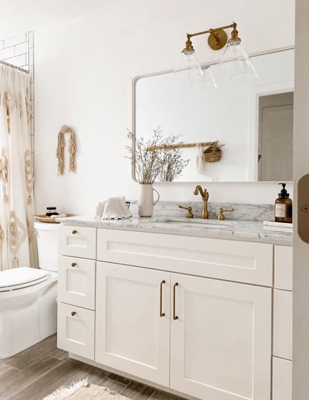 An all white bathroom beauty in all its lovely antique brass finishes! 

#LTKhome #LTKfindsunder50 #LTKfindsunder100