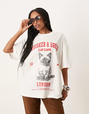 ASOS DESIGN oversized t-shirt with cat cafe graphic in cream | ASOS (Global)