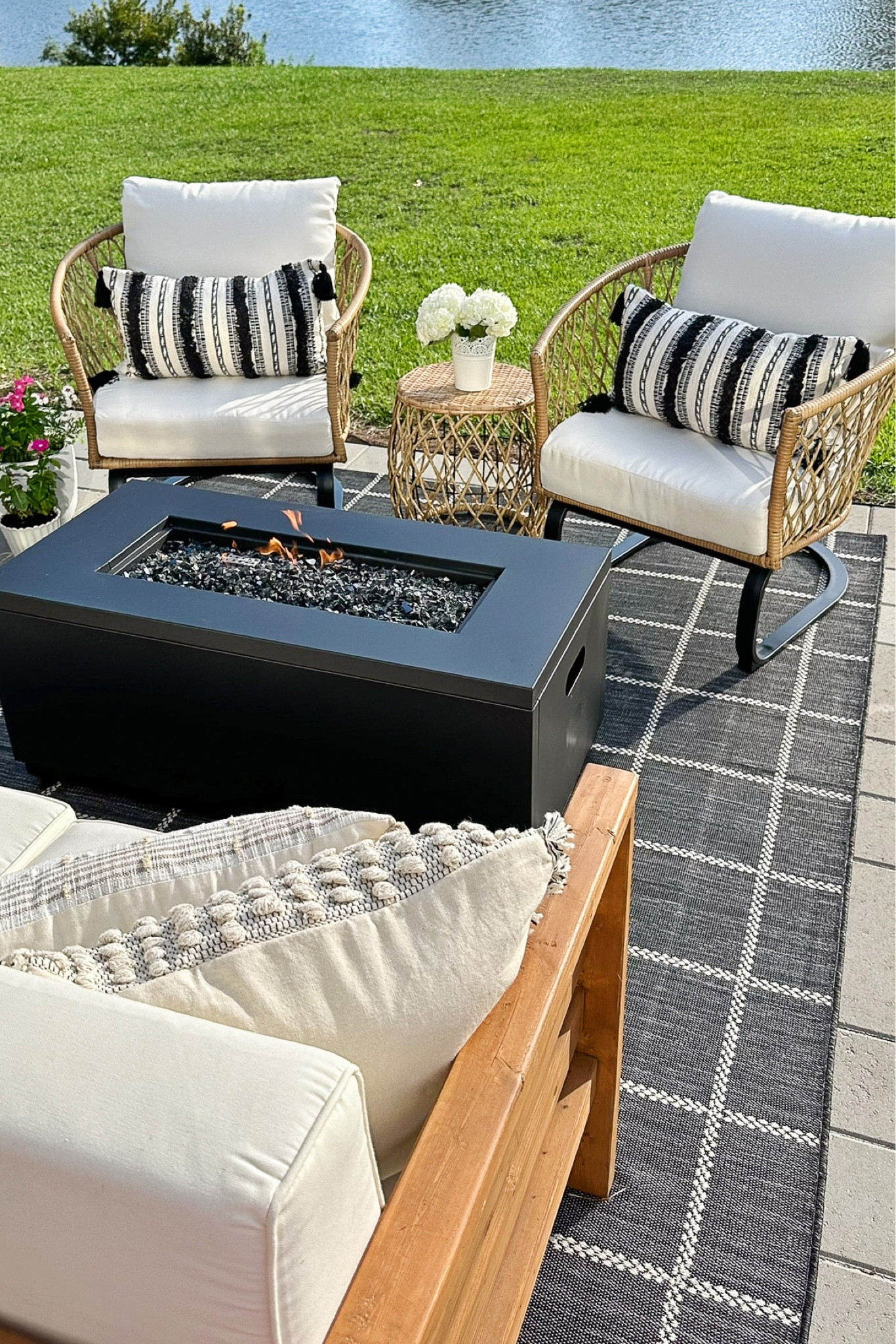 Outdoor living space with outdoor furniture and decor from Walmart, smokeless fire pit, wicker outdoor chair and table set, throw pillows

#LTKSeasonal #LTKSaleAlert #LTKHome