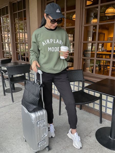 Airport outfit ideas
Comfy casual outfit
Green airplane mode sweatshirt, wearing size M
Woven tote bag
Black sweatpants
Rimowa suitcase, i am adfing some affordable options.

#LTKstyletip #LTKtravel