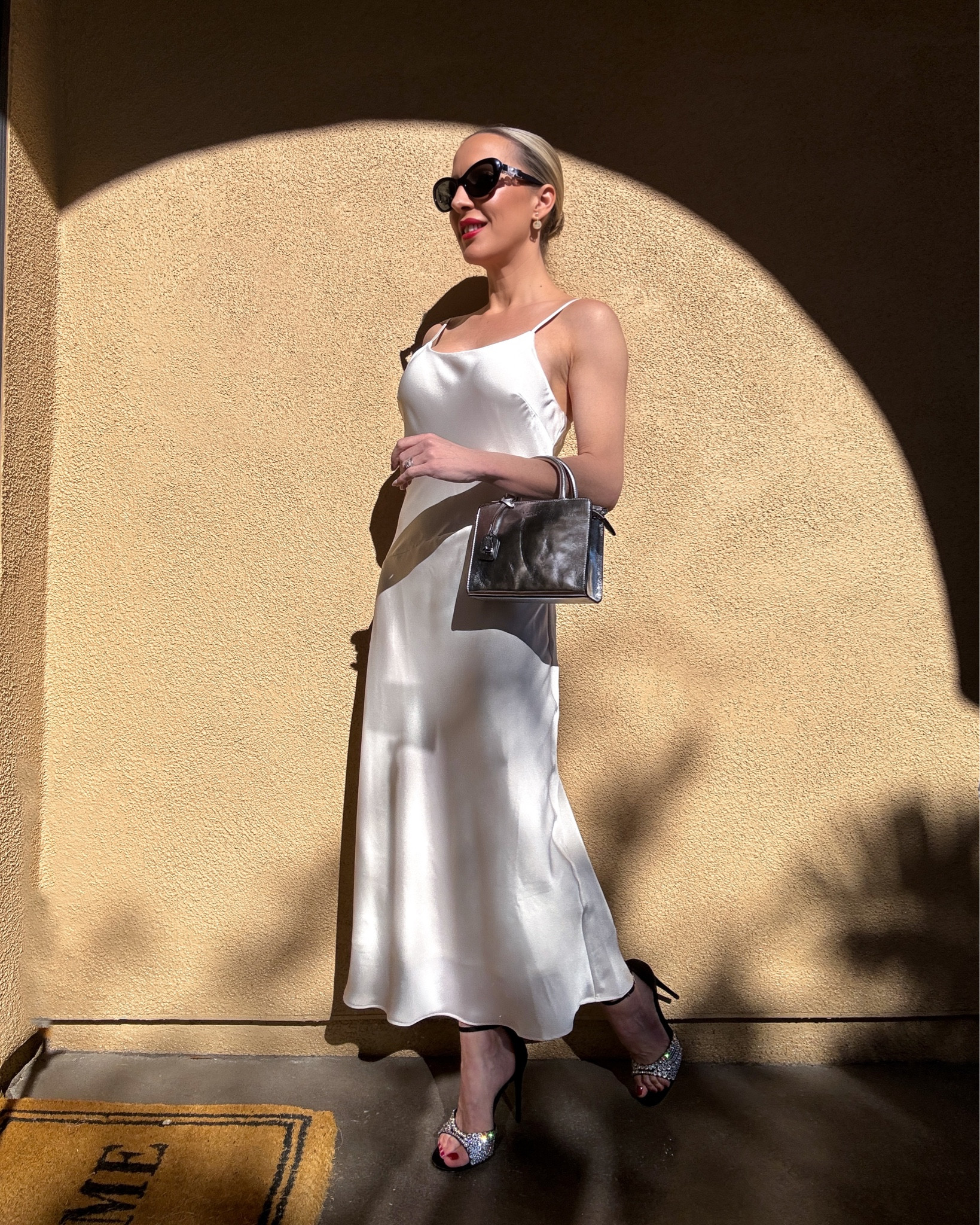 This ivory satin slip dress is on sale for under $40. It comes in lots more colors and works for all seasons. Styled on its own or over a long sleeve bodysuit or turtleneck sweater. Gucci crystal sandals, silver mini top handle bag and red lipstick are perfect for the holiday season and all of your holiday party outfits. 

#LTKSeasonal #LTKparties #LTKHoliday