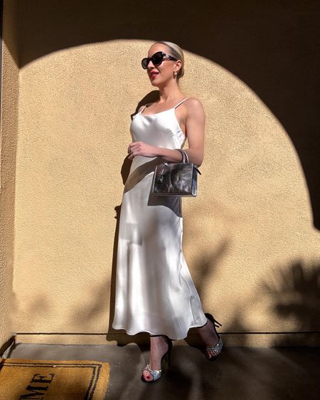 This ivory satin slip dress is on sale for under $40. It comes in lots more colors and works for all seasons. Styled on its own or over a long sleeve bodysuit or turtleneck sweater. Gucci crystal sandals, silver mini top handle bag and red lipstick are perfect for the holiday season and all of your holiday party outfits. 

#LTKSeasonal #LTKparties #LTKHoliday