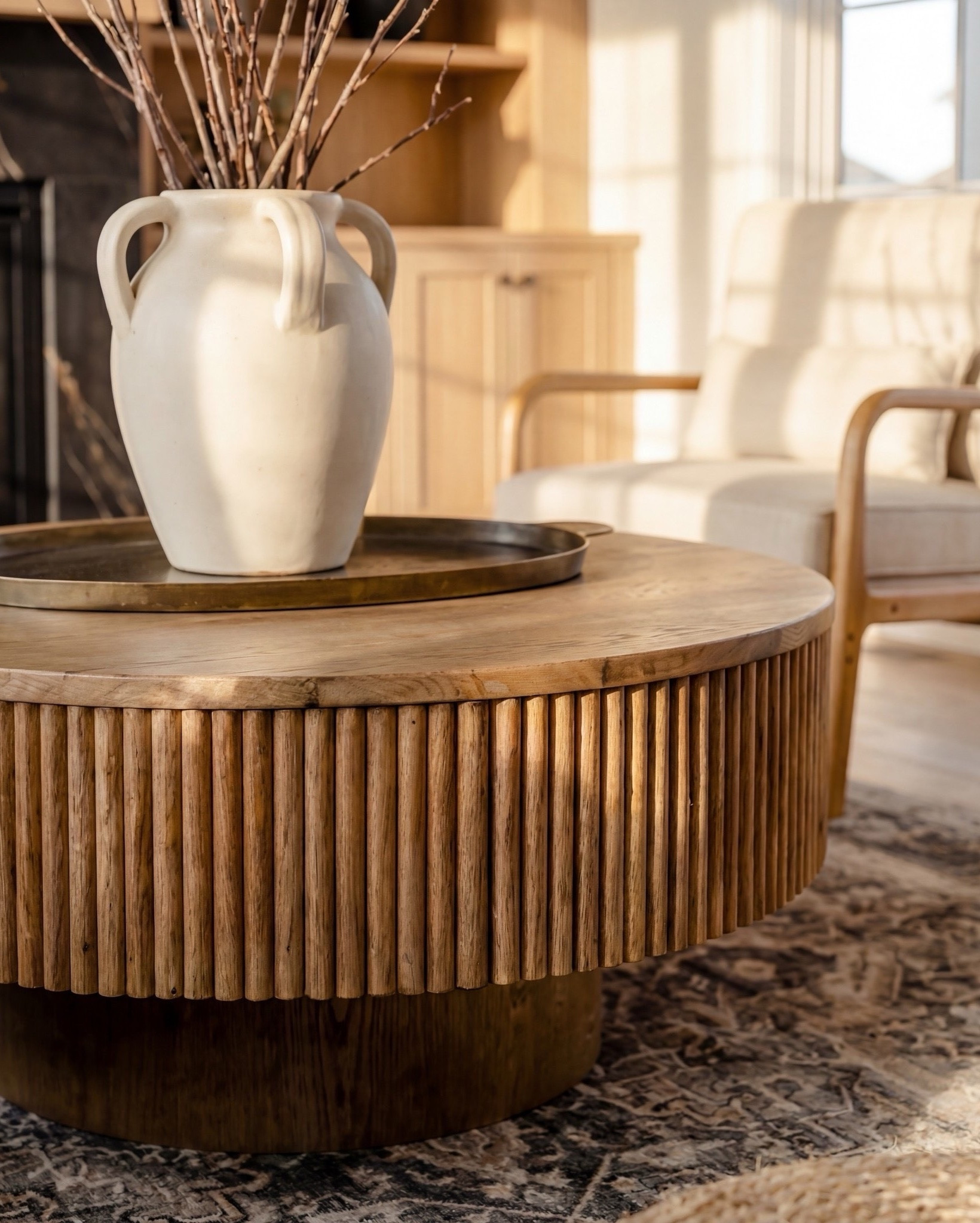 Shop the Look:
• White boucle curved sofa
• Fluted round wood coffee table
• Fluted honey-oak side table
• Oversized chunky knit throw in caramel brown
• Neutral patterned and solid throw pillows
• Natural oak accent chairs with cream cushions
• Woven round jute poufs
• Vintage-washed neutral area rug
• Black marble fireplace surround
• Large white ceramic vase with branches
• Light oak built-ins with modern styling decor
• Globe pendant ceiling light

#LTKSaleAlert #LTKSpringSale

#LTKsale #LTKhome