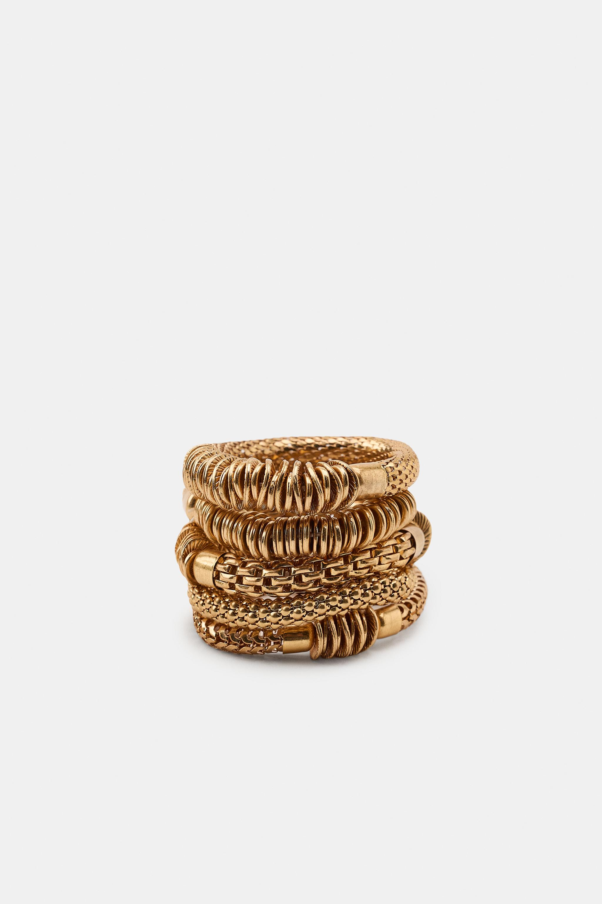 Pack of five elastic bracelets with metallic pieces in various shapes and sizes. | Zara US
