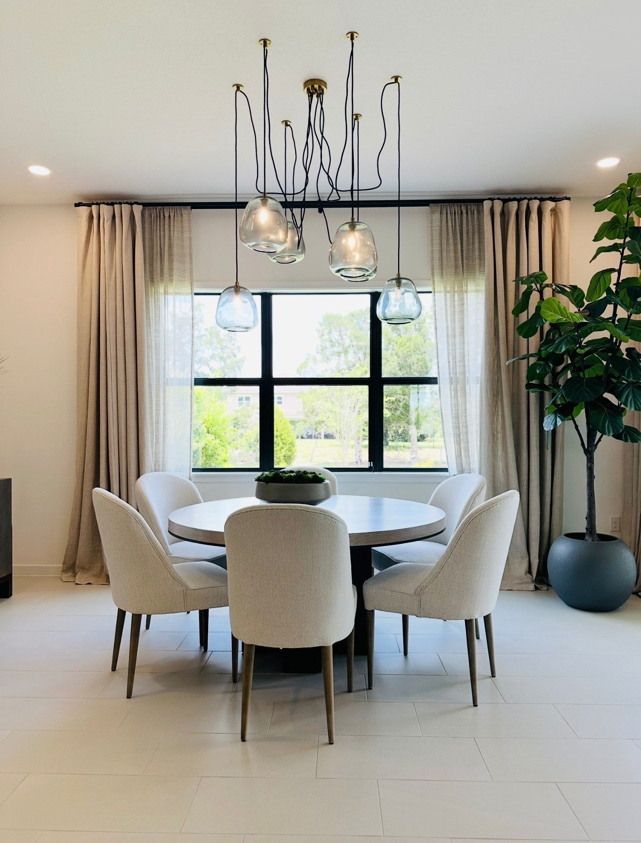 Ready to elevate your dining room design?  Minimalist Neutral Dining Room Design with table, off white chairs and Modern Lighting with a oversized faux fiddle tree

#LTKFindsUnder100 #LTKHome #LTKStyleTip