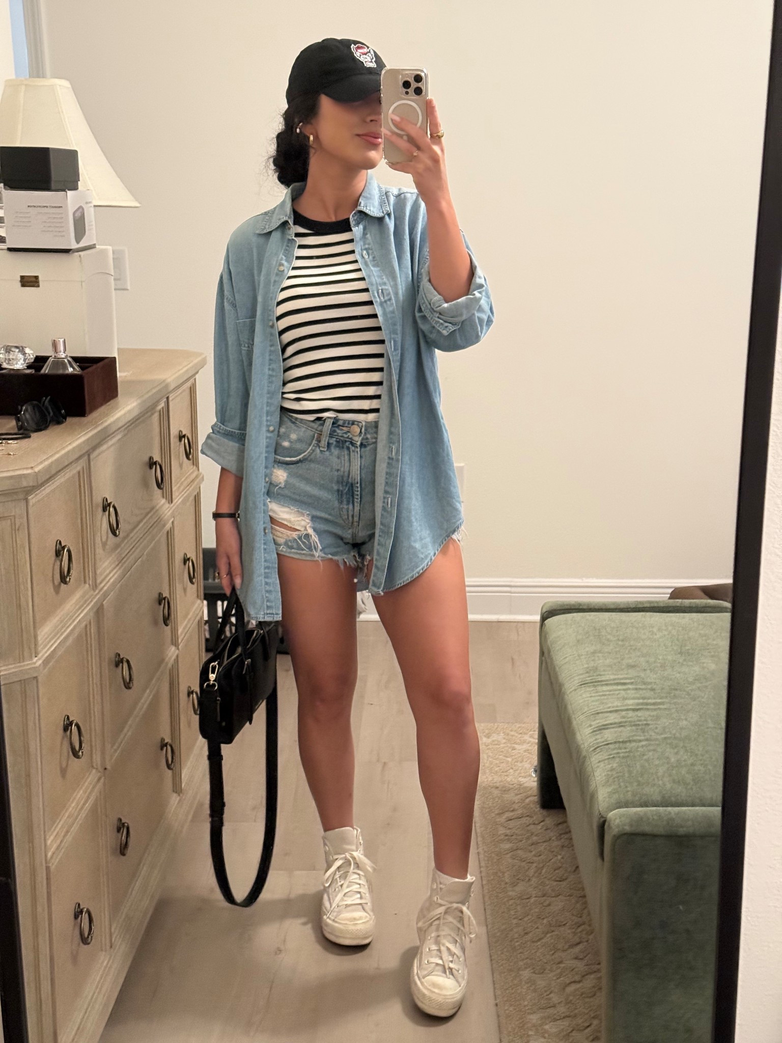 Cute transitional game day outfit! Perfect outfit for football or baseball games or even running errands outdoors. I paired a striped tank with ripped jean shorts, high top converses, and a casual denim shirt and team baseball hat to bring it all together. Hair in a low bun with some cute gold accessories elevates the look even more!

#LTKStyleTip #LTKFindsUnder50