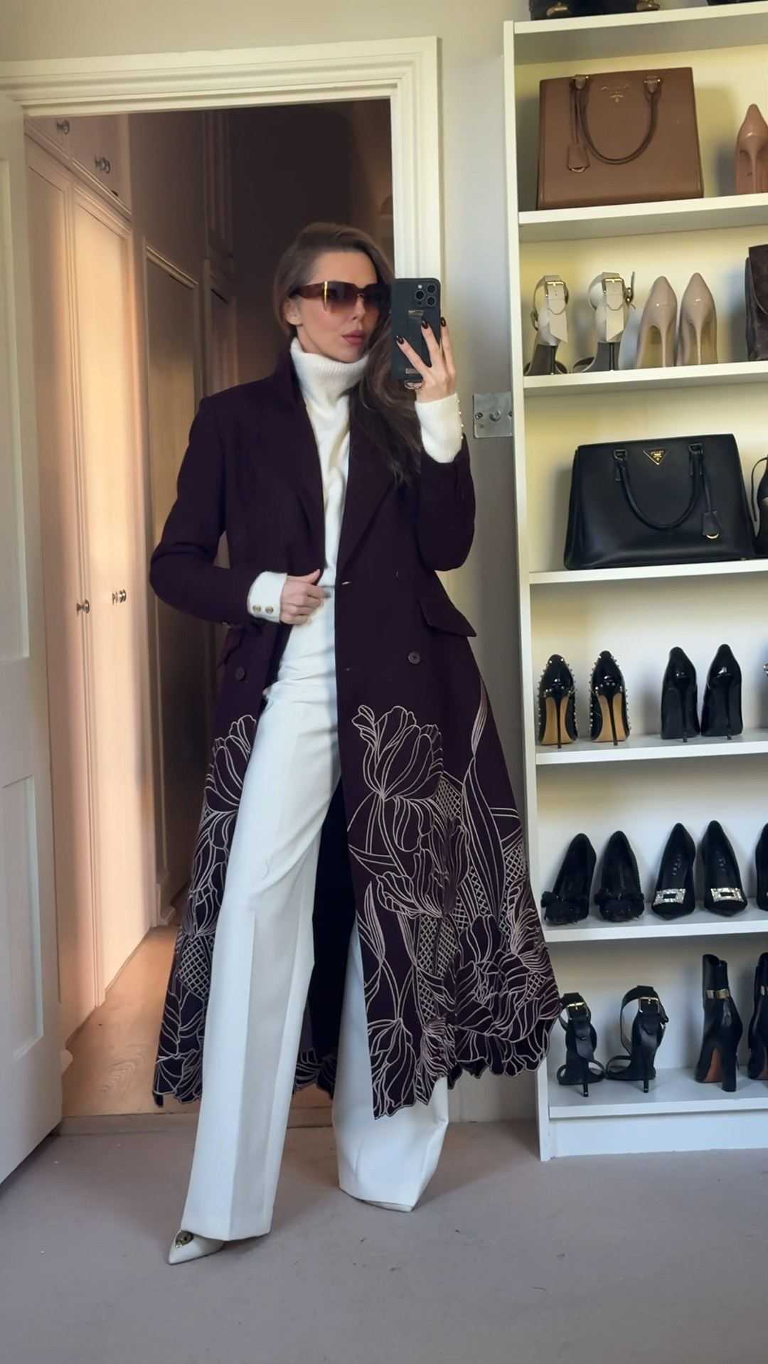 This chic outfit features a burgundy floral overcoat paired with a white turtleneck sweater and high-waisted, wide-leg white trousers. The look is completed with statement sunglasses, creating an elegant, fashion-forward style perfect for fall.

Use code LAURA15 for discount at Karen Millen ad

#LTKuk #LTKeurope #LTKautumn