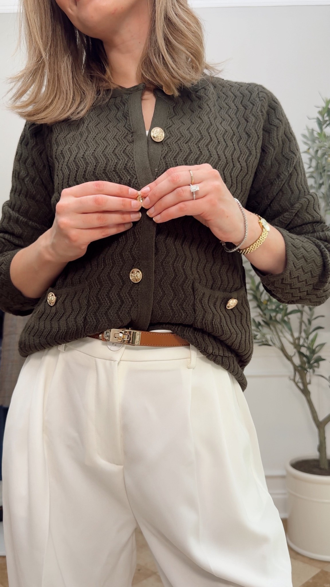 old money inspired outfit for coffee shop dates
green sweater cardigan with gold buttons, hermes look for less belt, white trousers 

 #LTKStyleTip #LTKWorkwear #LTKTravel