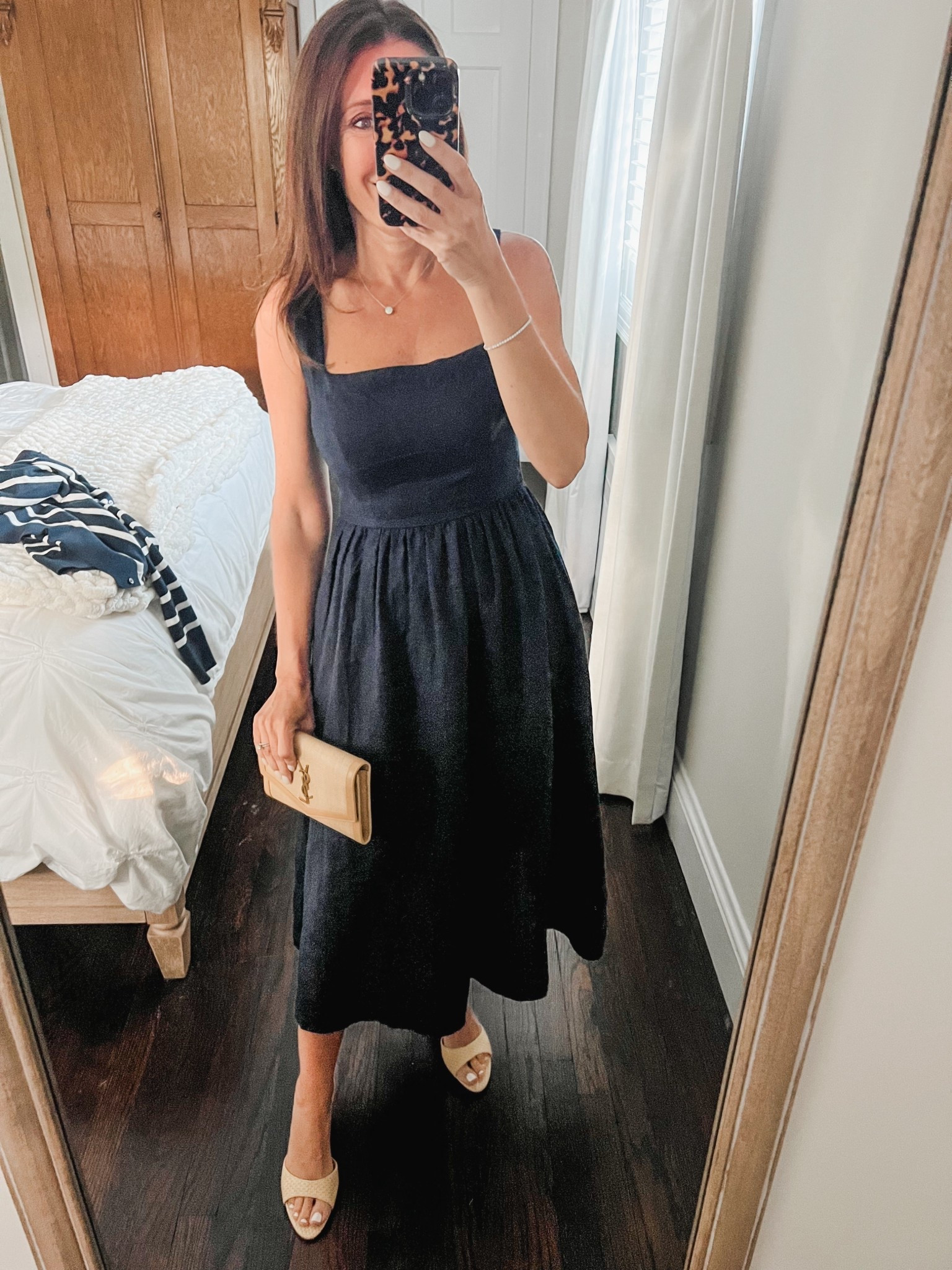 Date night outfit.  This navy blue linen dress is an affordable option from Quince.  I am wearing an xs and the straps are adjustable.  If you have not shopped from them before, try it! Returns are super easy.
The shoes and bag are my staples for date and event nights.  I have had the bag for two or three years and it was worth the splurge.