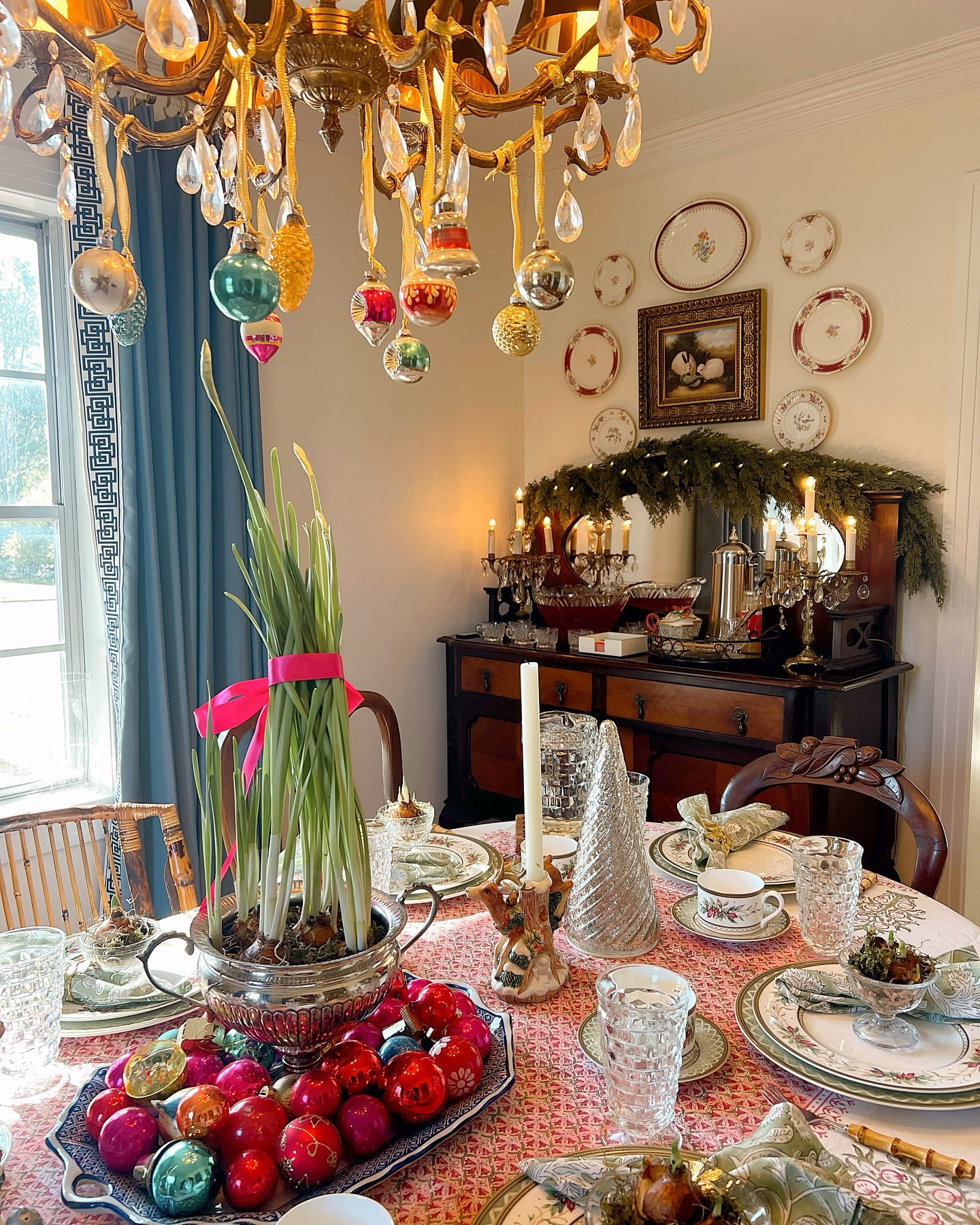 There’s nothing quite like gathering around a beautifully set table to celebrate the season with friends who make work feel like family. Last week, I hosted a luncheon for my coworkers, and it was a festive blend of vintage charm, meaningful details and holiday cheer! 🎄✨

I set the table with my treasured Fitz and Floyd Winter Holiday china, layered over a gorgeous pink and green block print tablecloth from @lovely_lady_linens. The centerpiece was a silver vessel of blooming paperwhites (my favorite winter flowers!) surrounded by a chinoiserie tray of vintage ornaments for a touch of sparkle.

To thank my team for their hard work this year, I gifted each with their own potted paperwhite bulb nestled in a thrifted sherbet cup. I loved sharing one of my favorite holiday traditions with them. 

We enjoyed finger foods, salad, punch and coffee. It was a sweet, simple reminder that the best part of the holidays is connecting with those who bring joy to our lives.
•
•
•
•
•
•
Vintage Home Style | Vintage Decor | Vintage Holiday Decor | Eclectic Style | Maximalist Home | Colorful Home | Home Inspiration | Holiday Styling | Collected Home | Vintage Christmas | Curated Home | Christmas Traditions | Traditional Christmas | Traditional Home | Holiday Entertaining

#tablescapetuesday #christmastable  #thesentimentaldecorator #holidayhosting #sentimentalstyle #holidaystyling #holidayentertaining  #joyfullysingle #vintagechristmas #herbeautifulhaven #curatingajoyfullife #vintagehavenforone