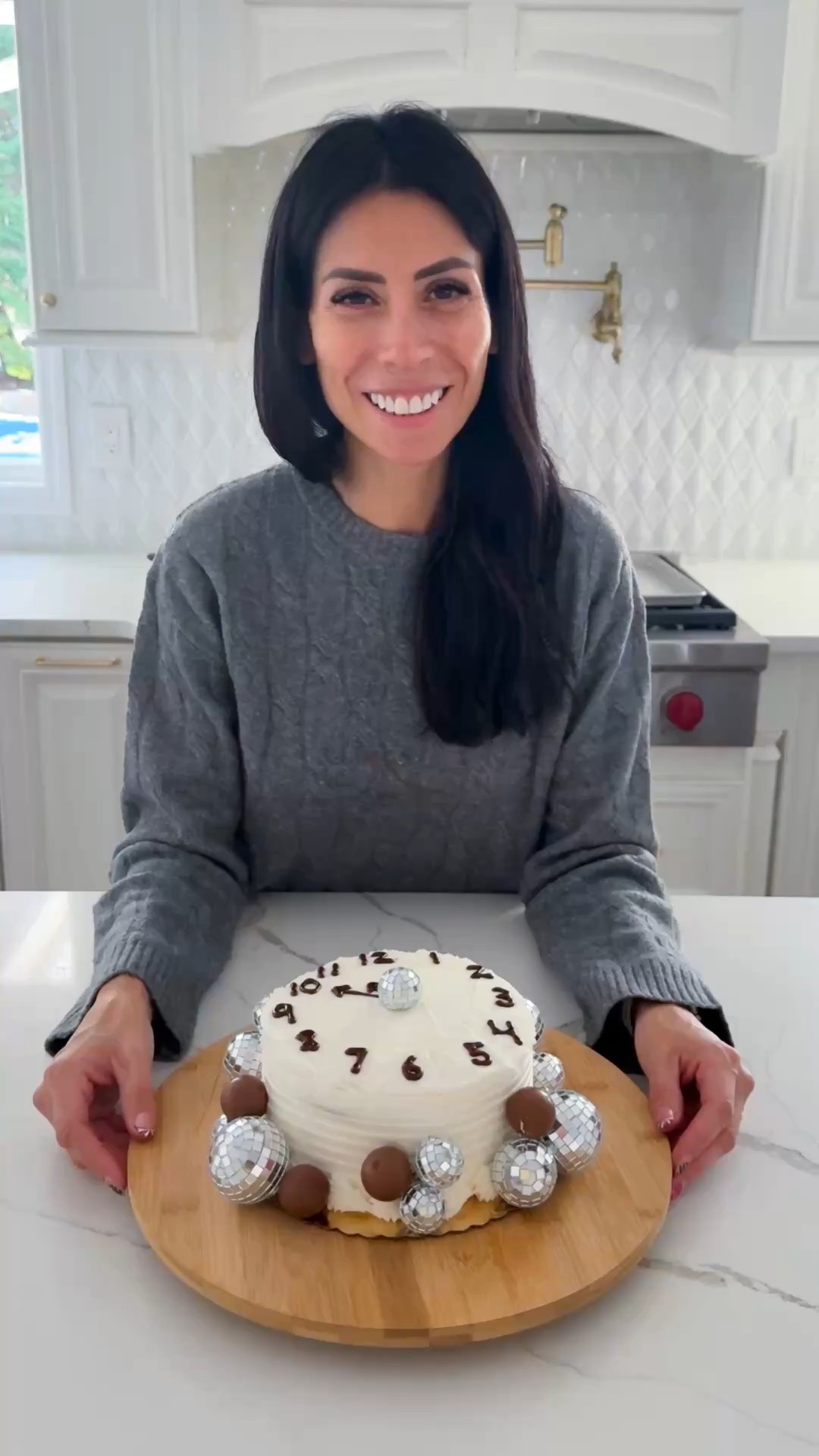 NYE countdown cake! Transform a simple store-bought cake...
• 1 store bought cake with vanilla frosting 
• black piping gel or chocolate icing
• variety sizes disco balls
• Lindt chocolate truffles 
Take excess frosting from the top of the cake and smooth down. Write the clock numbers using chocolate or black frosting. Add disco balls and chocolate truffles to decorate. 

#LTKfoodie #LTKSeasonal #LTKHoliday