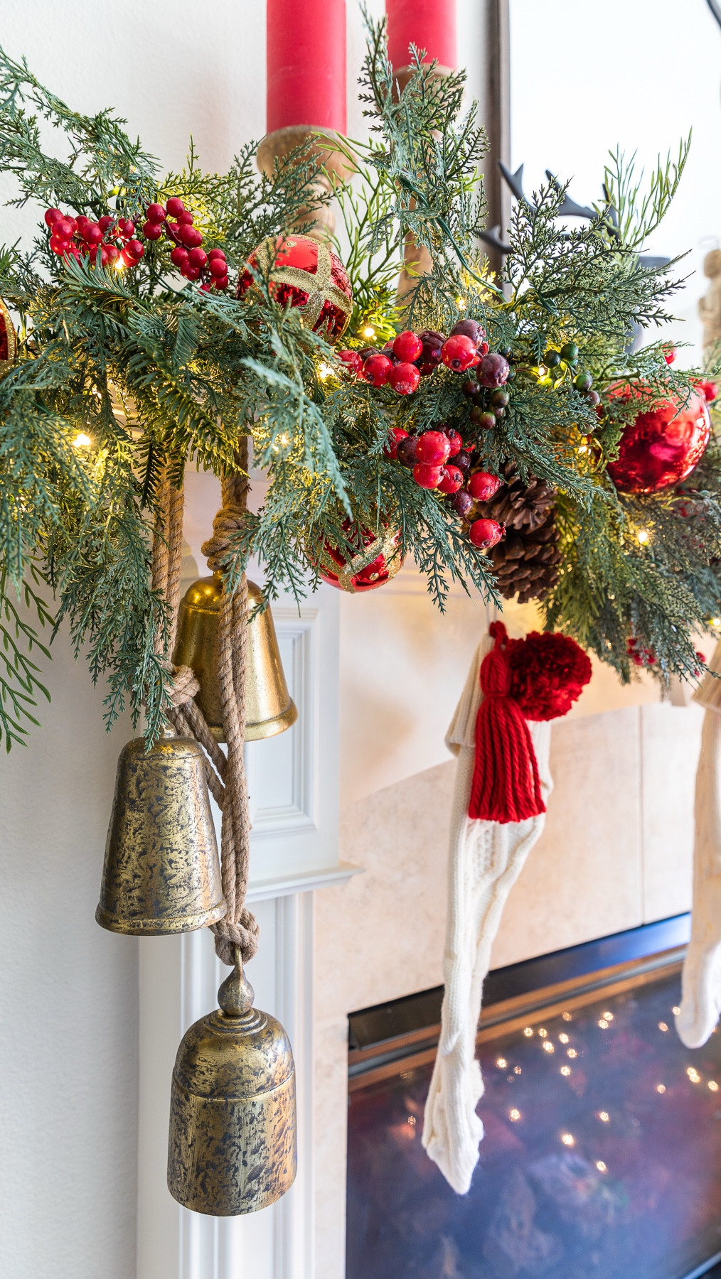 Christmas mantel decor with simple accents like bells, berries, and ornaments. Pre lit, battery operated Christmas garland with pinecones and berries  

#LTKSeasonal #LTKHoliday #LTKHome