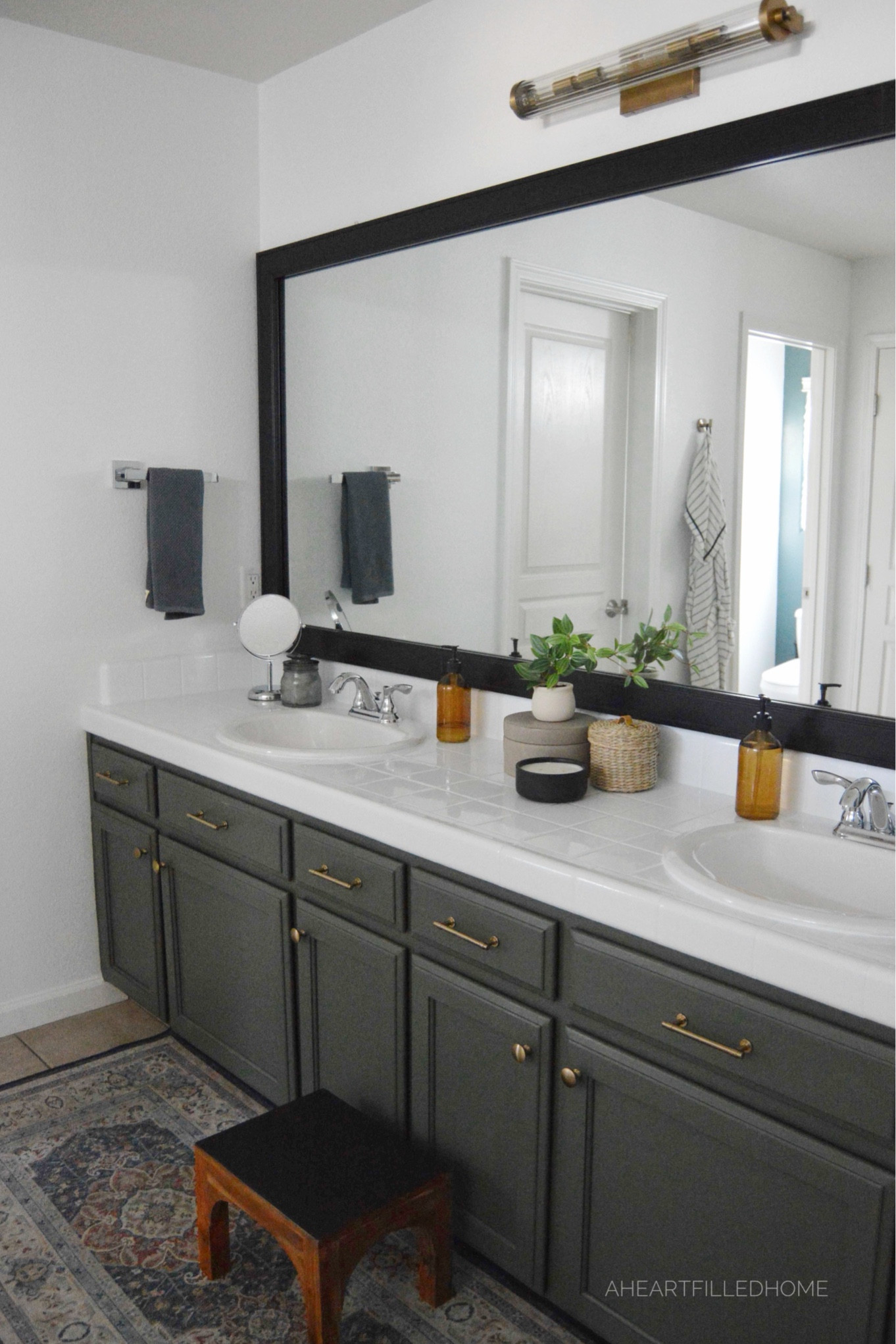 Bathroom makeover including new faucets, towels, soap dispensers, drawer knobs, drawer pulls, vanity light, rug, and more!

#LTKhome #LTKfindsunder50 #LTKfindsunder100