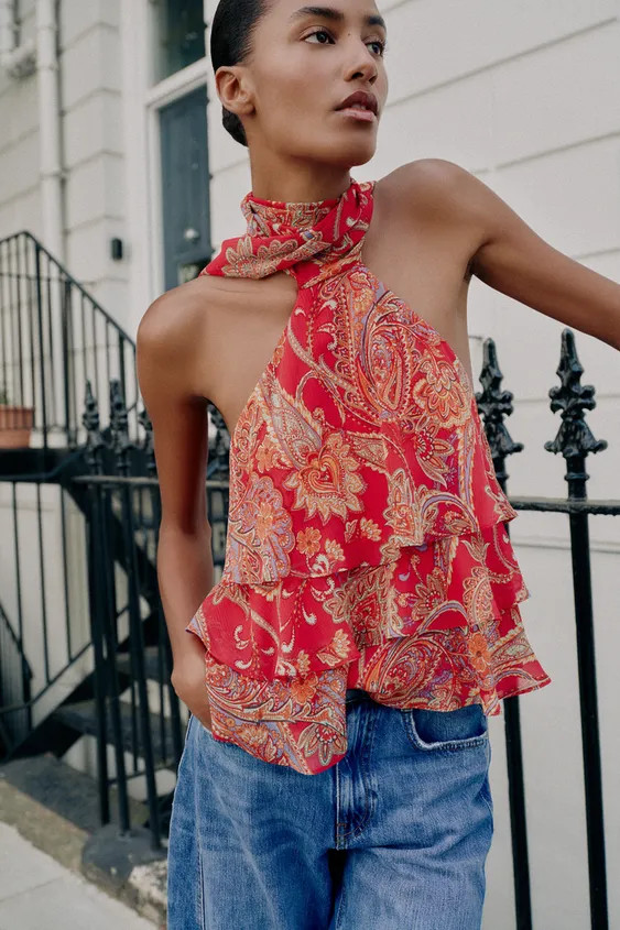Halter neck top featuring a tie detail and open back. Front ruffle details. Lined. Back hidden bu... | Zara US