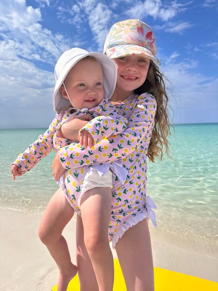 My little matching sisters 🫶🏼🐚🏝️Perfect for these sunny beach days. I’ve never been big on the long sleeve swims but e got burnt and I’m so glad we had them!! 

#LTKswim #LTKbaby #LTKkids