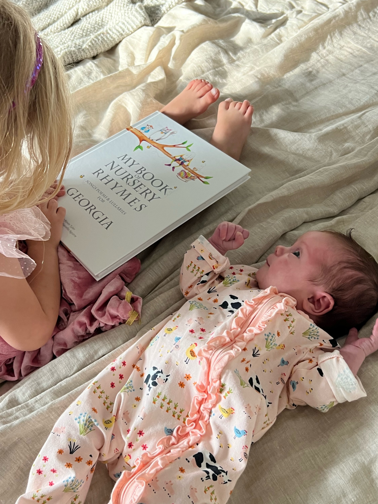 Big sister reading baby sister her first personalized book of nursery rhymes! So many adorable personalized books from this shop I love them all!! 

#LTKbaby