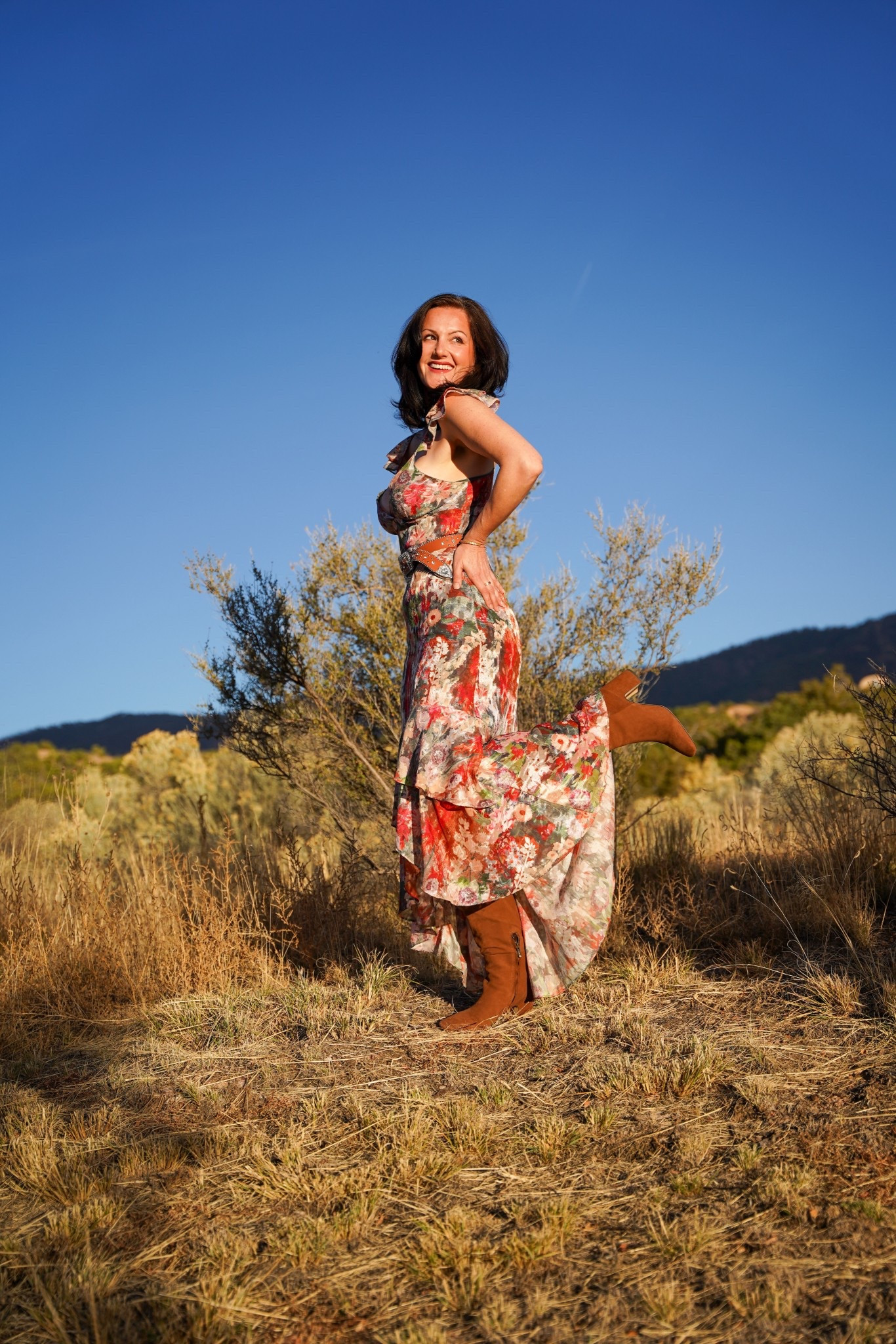 Floral midi dress with western boots, styled for spring. This boho western outfit pairs a flowy floral dress with suede ankle boots, creating an easy spring look for travel, weekend outfits, outdoor dining, and warm-weather layering. 

#LTKTravel #LTKSeasonal #LTKootd