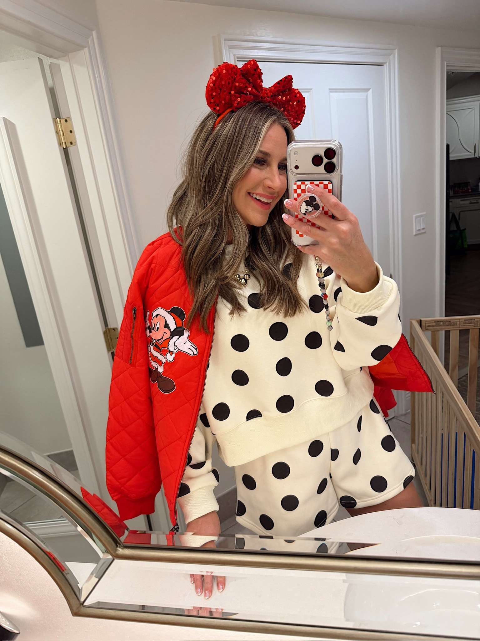 In a medium polka dot sweatshirt and shorts, medium jacket with iron on patch, sequin Minnie Mouse ears and accessories - what to wear at Walt Disney World at Christmas! 

#LTKHoliday #LTKootd #LTKTravel