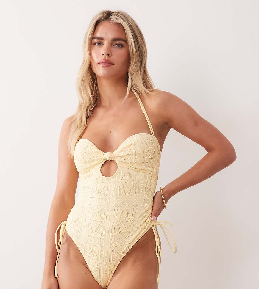 ASOS DESIGN Petite Kyle eyelet twist front knot one-piece swimsuit with side tie detailing in buttermilk-Yellow | ASOS (Global)