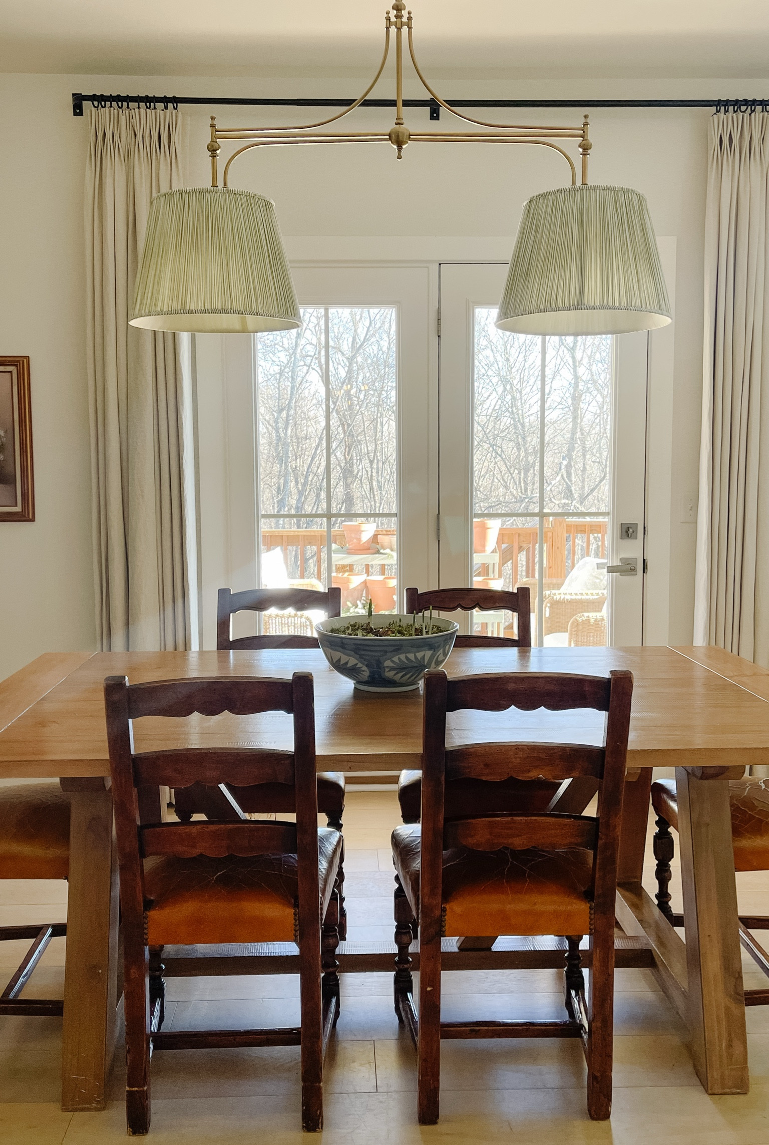 Our Dining Room - we paired the Ballard Designs light fixture with pleated lampshades from Pooky Lighting. Our dining room table is old from World Market, chairs are vintage. Linking similar options! ------
traditional home, classic home styling, Southern home, farmhouse, ladder back chairs, vintage, pleated lampshade, blue and white, Ballard Designs 

 #LTKHome