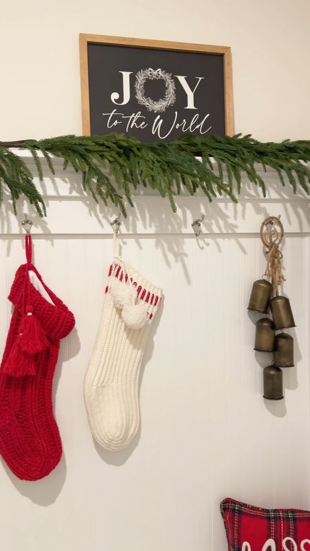 Mudroom styling for Christmas. I used Norfolk pine garland, hanging bells, knit stockings and a festive pillow to create this look  

#LTKHoliday #LTKhome #LTKSeasonal