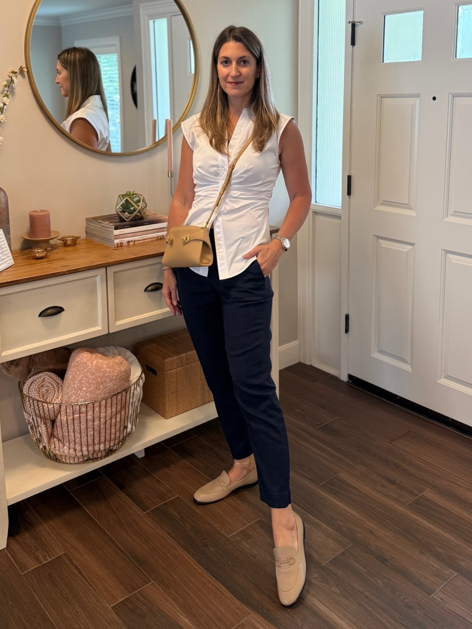 Love this take on a collared white shirt. The ruching is fun and offers a feminine fit throughout the mid section. Paired with navy linen blend trousers and camel accessories. 

Shirt runs TTS.

#LTKootd #LTKOver40 #LTKWorkwear
