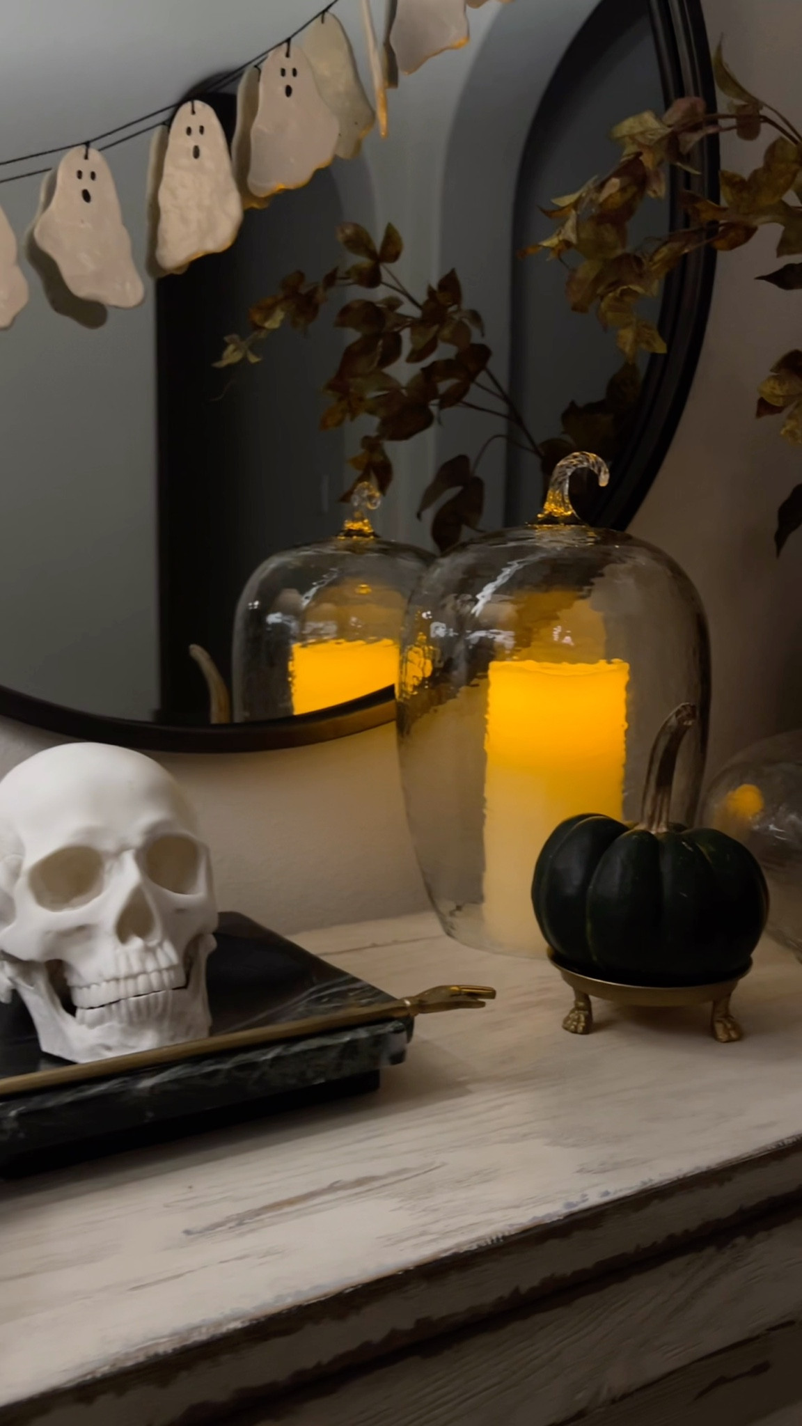 Spooky chic Halloween entry table decor with lifelike skull, clear glass pumpkin cloche, ceramic ghost garland, and faux fall branches.

The ghost garland is a DIY, but I’m linking to my inspiration.

Glass pumpkins are discontinued from Pottery Barn

#LTKHalloween #LTKHome #LTKSeasonal