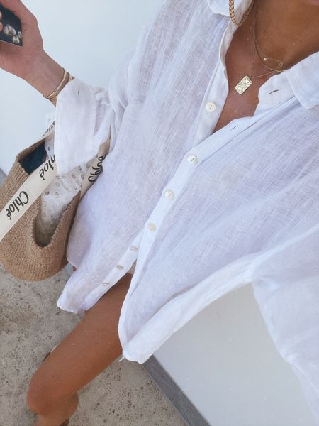 One of my most worn swimsuit cover ups is this simple oversized linen shirt. I'm wearing size small 