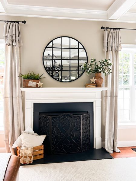 Neutral summer fireplace decorating. Drop cloth curtains with black clip on rings. Wicker vase with faux Stephanotis stems.

#LTKhome #LTKstyletip #LTKSeasonal