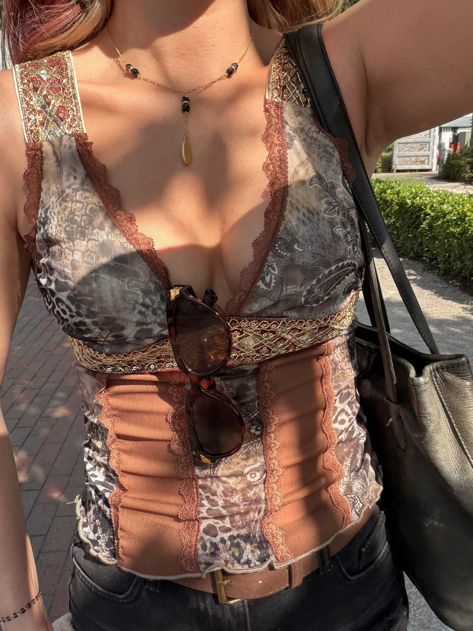 Vintage-inspired lace cami top with mixed prints, earthy tones, and corset-style details paired with black denim and layered gold jewelry. The patchwork print, lace trim, and fitted silhouette give this outfit an effortless cool-girl feel with a boho edge. Styled with a brown belt, black shoulder bag, and tortoise sunglasses for an elevated everyday look. lace cami top • boho outfit • patchwork top • vintage inspired outfit • cool girl style • brown aesthetic outfit • going out top • effortless outfit • western boho • neutral outfit inspo

#LTKootd #LTKdayinmylife #LTKgrwm