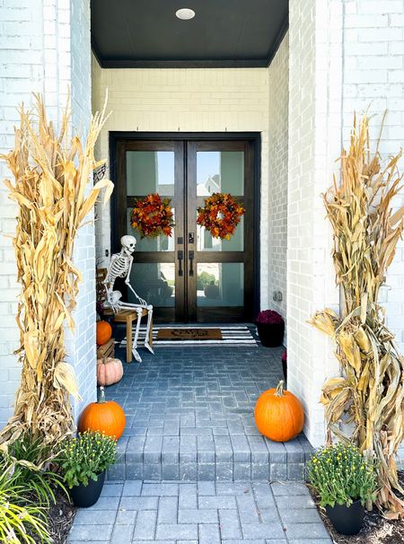 Fall front porch with Halloween decor

Wreaths from hobby lobby 
Corn stalks and mums from local nursery 

#LTKhome #LTKHalloween #LTKSeasonal