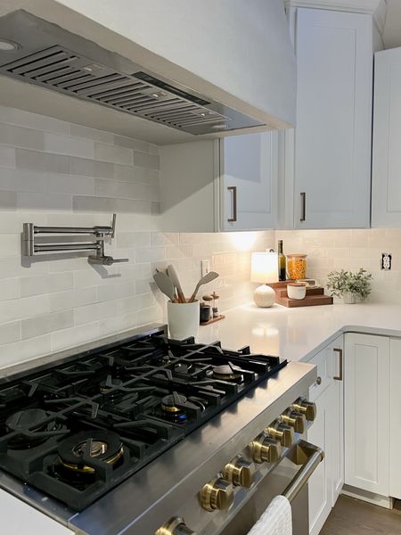 White grout was the move! 😍 the way it brightens and softens the space is perfect. ZLine kitchen appliances with gold cabinet hardware. Cute kitchen decor from Target and Amazon. 
#utensils #potfiller #venthood

#LTKhome #LTKunder50