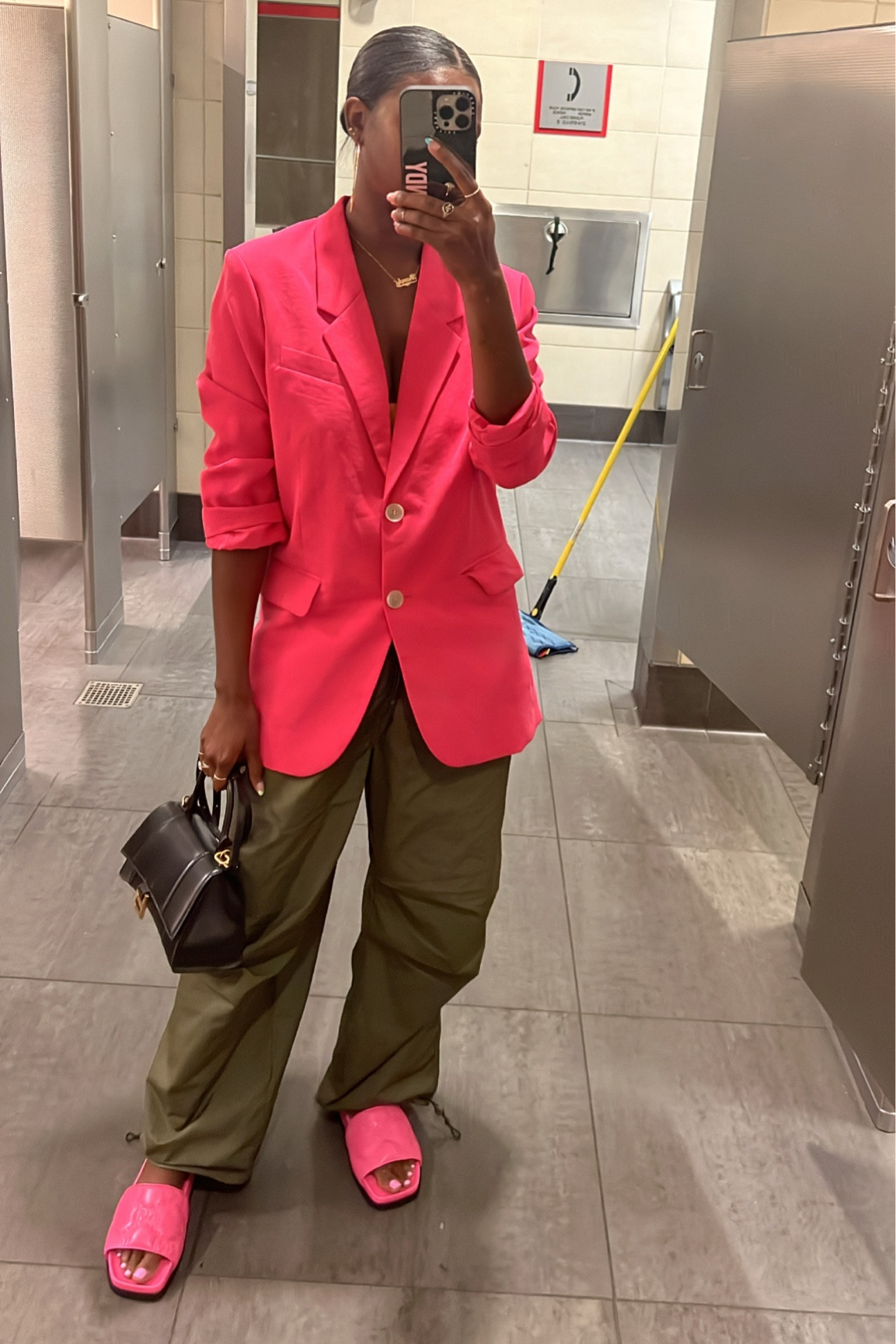 Blazer chic airport outfit. Pink blazer, green parachute pants, pink Gucci slides and black Balenciaga hourglass purse  

#LTKtravel #LTKSeasonal #LTKshoecrush