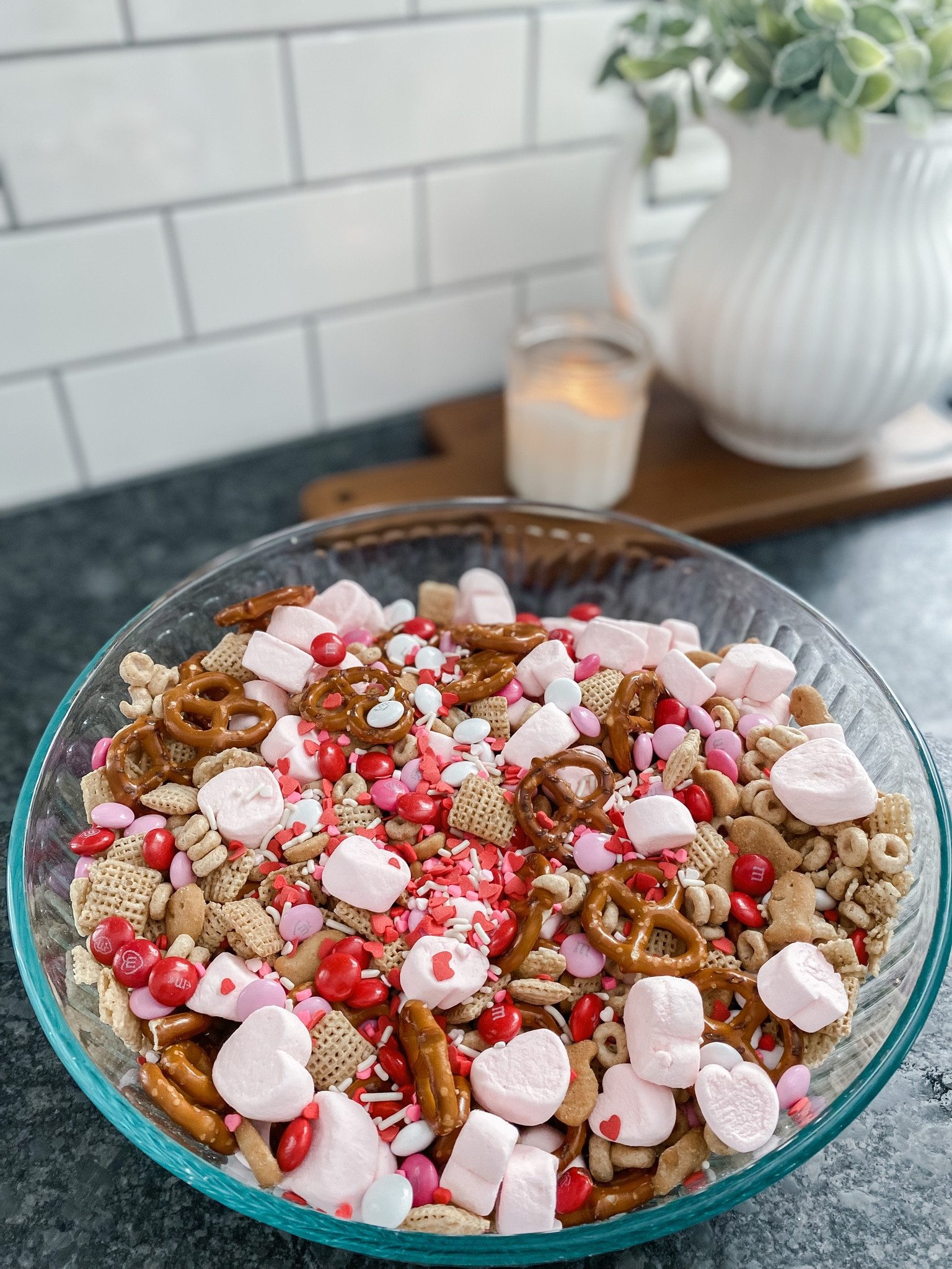 Valentine trail mix that’s festive, fun, and super yummy! Includes pretzels, cheerios, rice chex, vanilla cupcake goldfish, Valentine M&Ms, heart shaped marshmallows, and sprinkles

#LTKkids #LTKSeasonal #LTKhome
