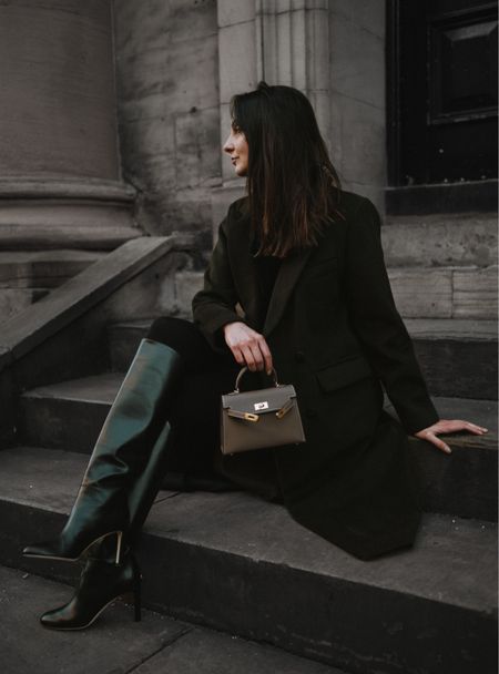 I love the stylish winter outfit combining a longline bottle green coat, knee high black smooth leather boots and a mini bag in taupe with gold hardware 🙌 #ootd #winteroutfit #falloutfit #winterlook 

#LTKSeasonal #LTKeurope #LTKstyletip