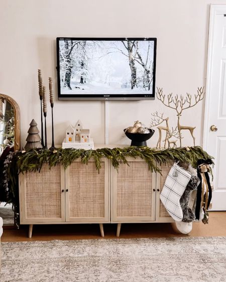 Tv console, console table, accent Cabinet, tv stand, holiday decor, stocking, reindeer, candle stick, village, ornaments, velvet ribbon, garland, 

#LTKSeasonal #LTKhome #LTKHoliday