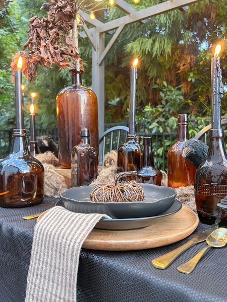 Create a spooky yet simple table scape this Halloween! Everything you need from plates to linens to silverware and a centerpiece styled with black candles and amber bottles. #halloween #tablescape

#LTKstyletip #LTKSeasonal #LTKhome